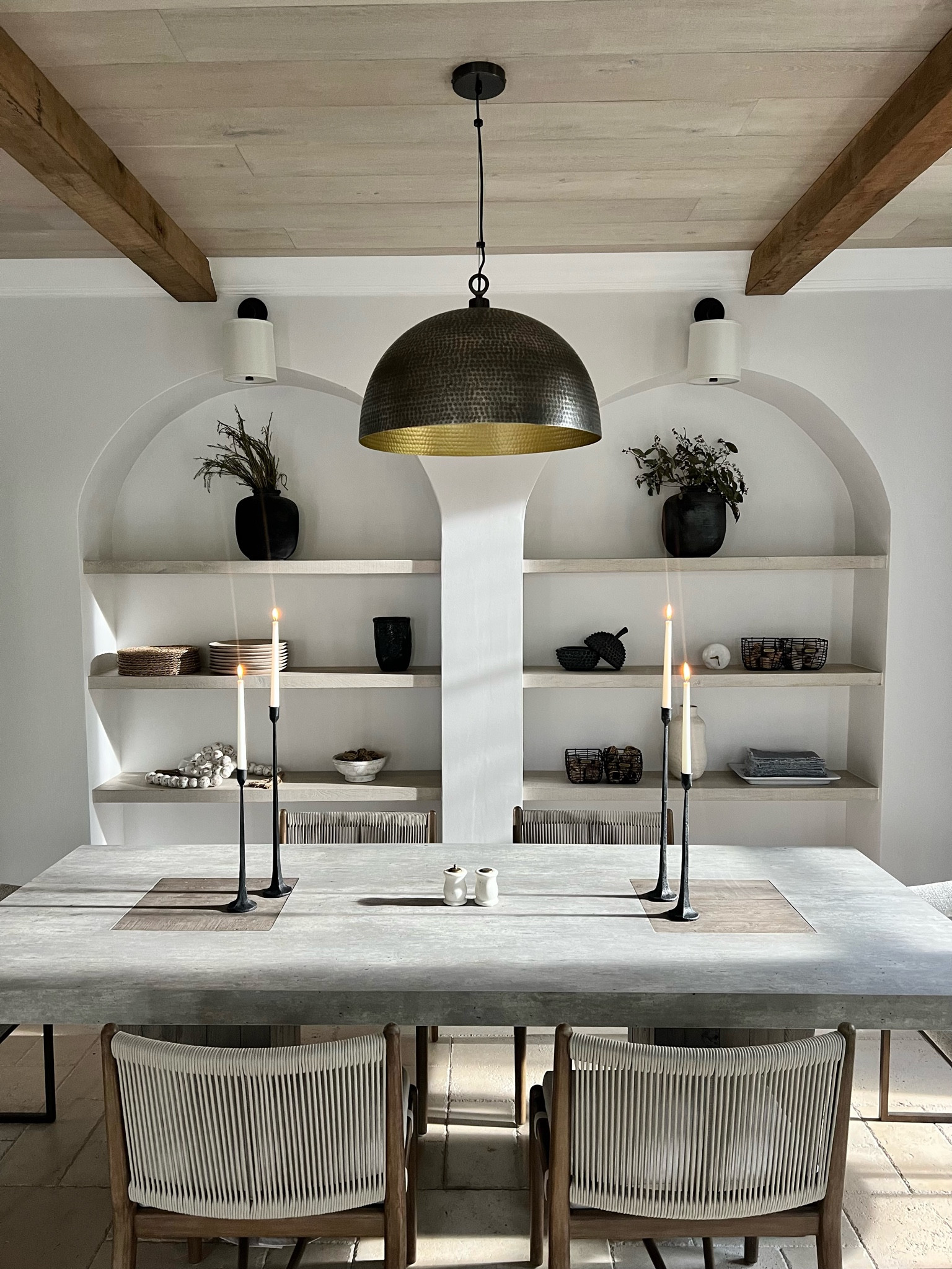 Time to dine! This dining room is inviting and warm because I used all natural elements. The floating shelves are wood (same exact wood I used on the ceiling), the dining table is cement, the chairs are woven and wood, and the greenery decor are real preserved stems! Nature gets the credit for why this is so beautiful! 

#LTKhome #LTKFind #LTKfamily