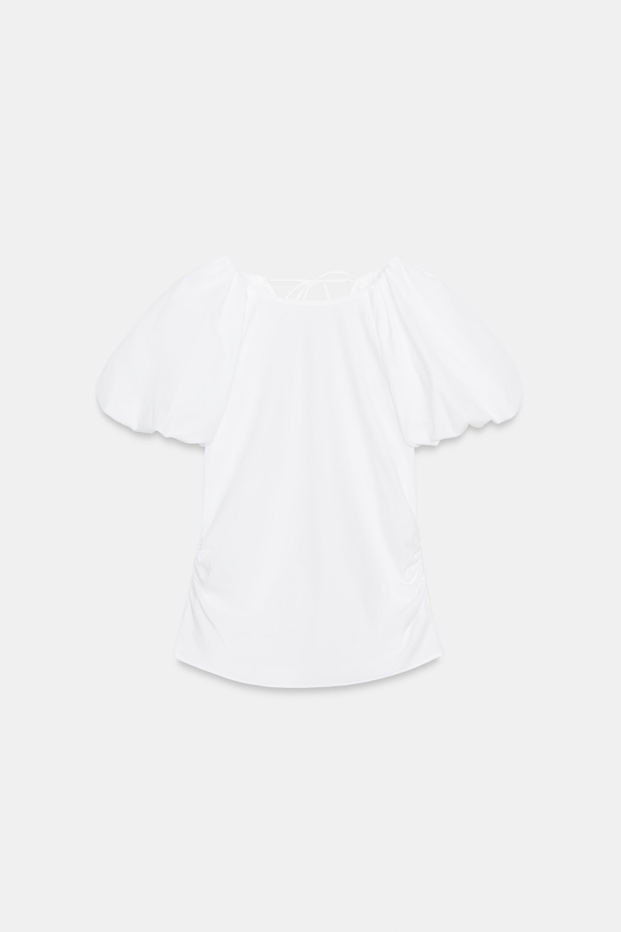 Round neck top with short balloon sleeves. Back opening with tie fastening in the same fabric. | Zara DE