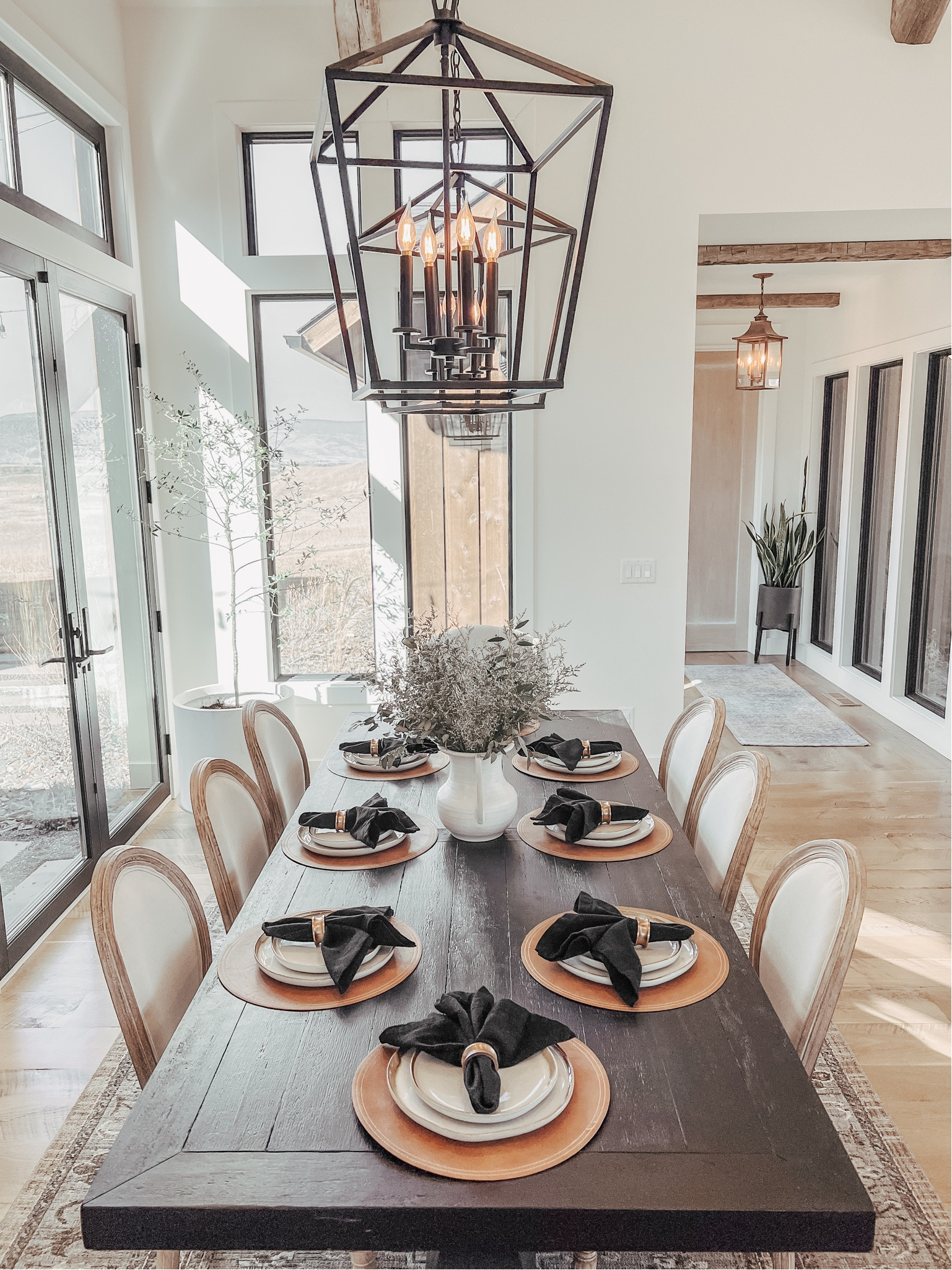 Huge black pedestal dining table with french modern chairs.


French country tablescape
Organic modern tablescape
Place setting
Dining table and chairs
Black table
Pedestal table
8 person table
Lantern modern chandelier 

#LTKHome