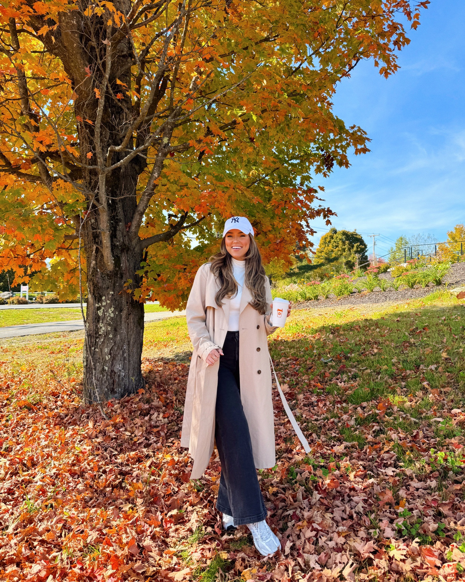 Trench coat outfit with white turtleneck and black jeans! Yankees baseball cap and gray sneakers.

#LTKFindsUnder100
