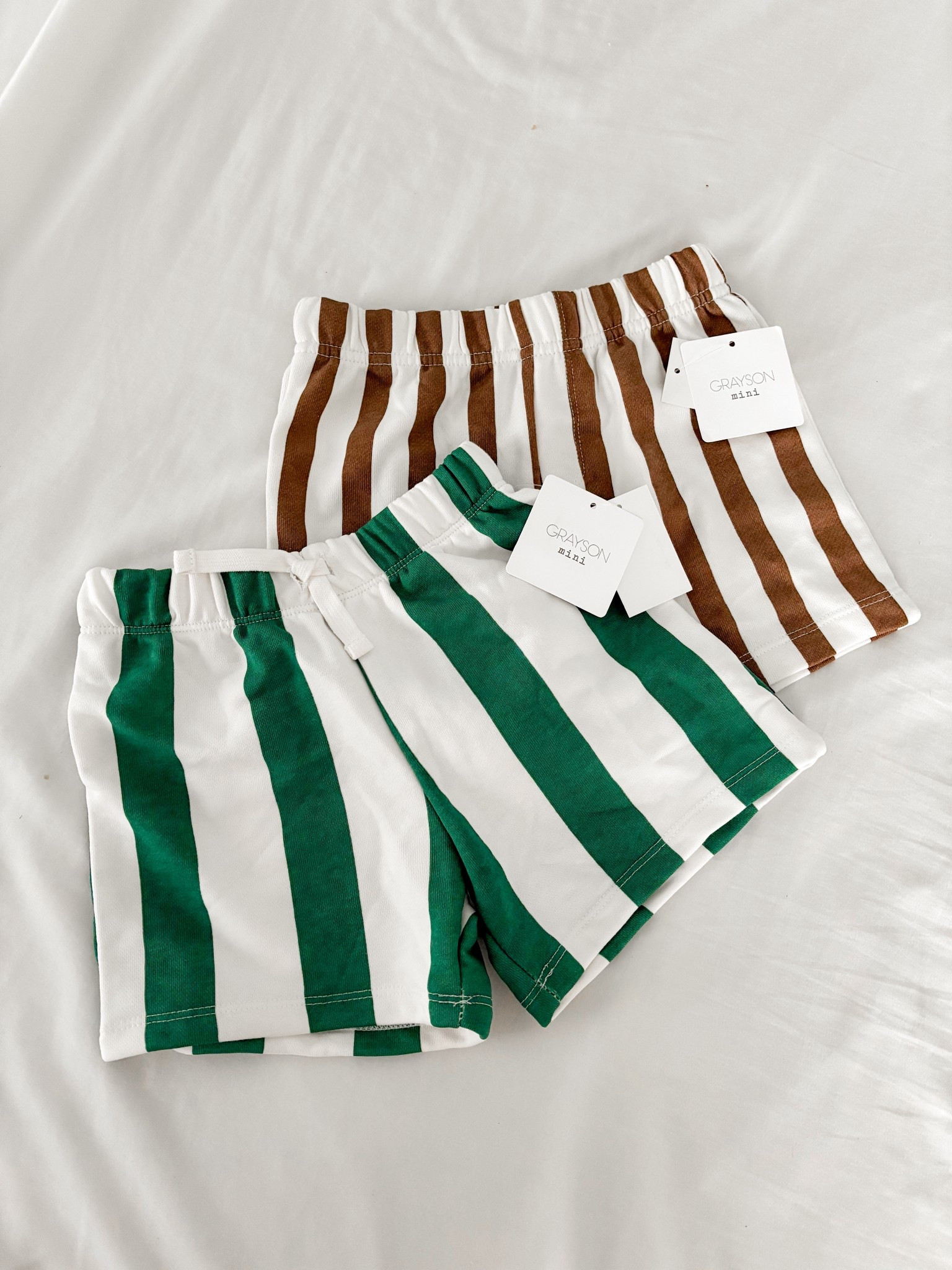 Striped summer staples for littles 🤍 Obsessed with these comfy neutral + green stripe shorts from Grayson Mini — the perfect mix of playful and classic. Easy to style for everyday play, park days, beach trips, and family vacations. Lightweight, soft, and made for busy kids who are always on the move. @Target 
.

kids fashion, toddler style, kids outfits, summer kids style, striped shorts for kids, toddler outfit ideas, neutral kids style, mini style, kids boutique clothing, everyday kids wear, kids fashion inspiration, toddler fashion, kids clothing brand, stylish kids outfits, mom life style, 

#LTKBaby #LTKTravel #LTKKids