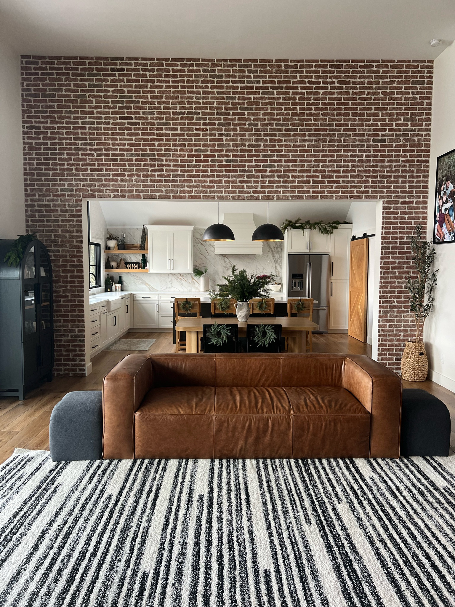 Living room, kitchen, home decor. Couch, ottoman. Arched bookcase. Olive tree. Lighting. Pendants. Kitchen table. Dining chair. Target. Walmart. Rug  

#LTKSeasonal #LTKHome #LTKFamily