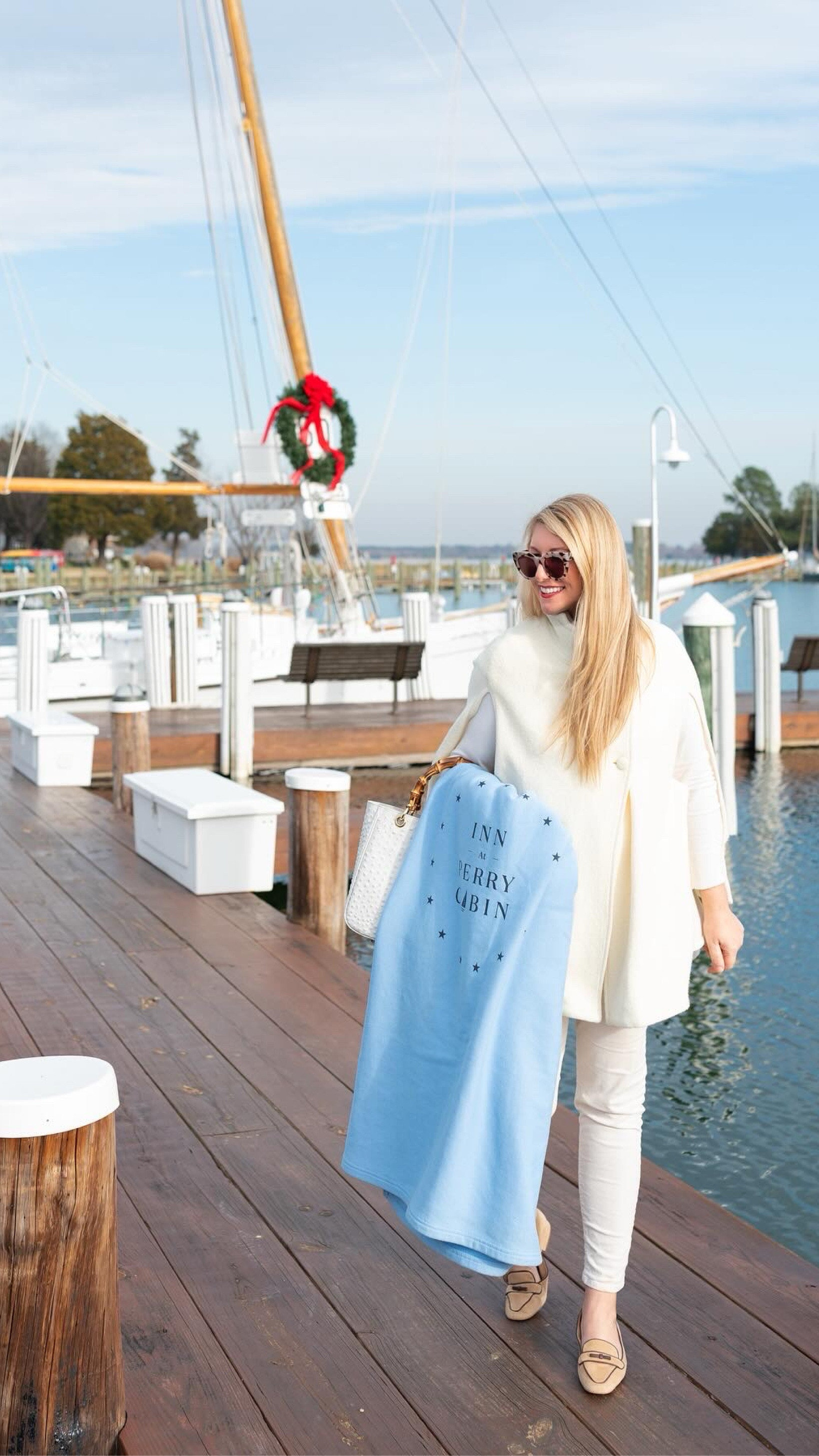 A perfect winter white outfit for holiday travels. Off-white wool cape, white corduroy pants, white turtleneck, light tortoise sunglasses, white ostrich pattern leather bamboo bag, and suede tan and brown leather loafers.

#LTKHoliday #LTKmidsize #LTKover40