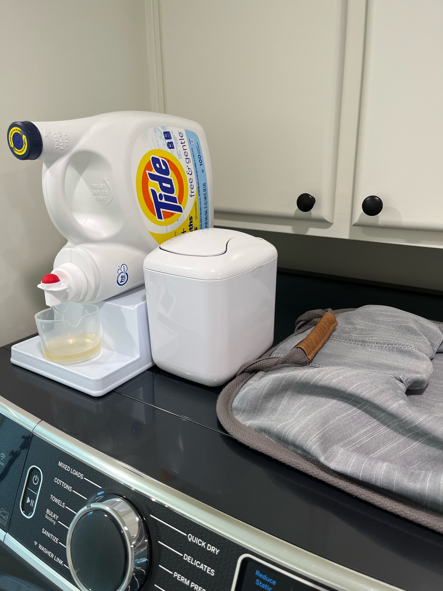 Three of my laundry favorites.  Detergent dispenser. Mini lint trash can and collapsible laundry basket