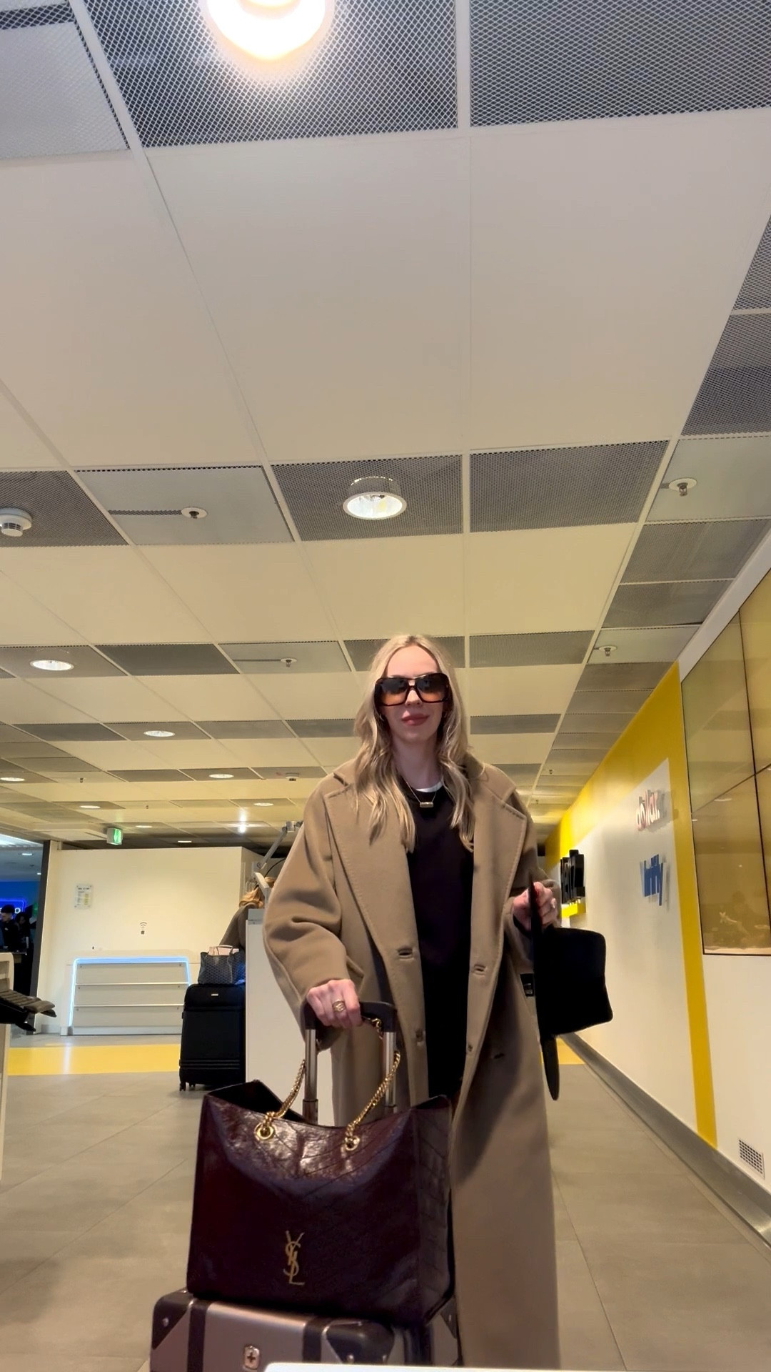 Waiting on our rental car at the airport - travel look of the day 

Camel coat, Amazon joggers, YSL burgundy tote bag, airport style

#LTKTravel #LTKootd #LTKdayinmylife