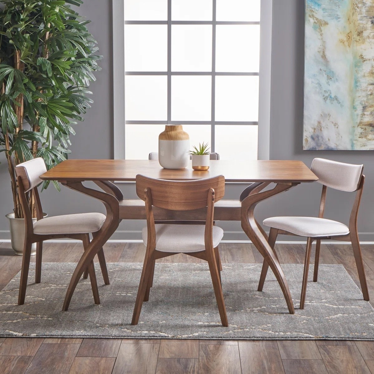 This 4-person dining set from Wayfair is a timeless choice for everyday meals and entertaining. Featuring a warm wood trestle table and four upholstered dining chairs, this set blends mid-century modern style with comfortable seating. Currently 11% off, it’s perfect for dining rooms, breakfast nooks, and open-concept spaces. The curved wood details and neutral upholstered chairs create a sophisticated, inviting look you’ll love year-round.