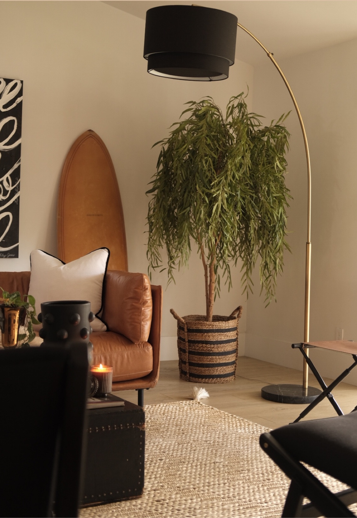 Living room decor! 
Arc lamp 
Willow tree 
Surfboard 
Jute rug 
Leather ottoman 
Leather sofa 
#meandmrjones 

#LTKunder50 #LTKhome #LTKunder100