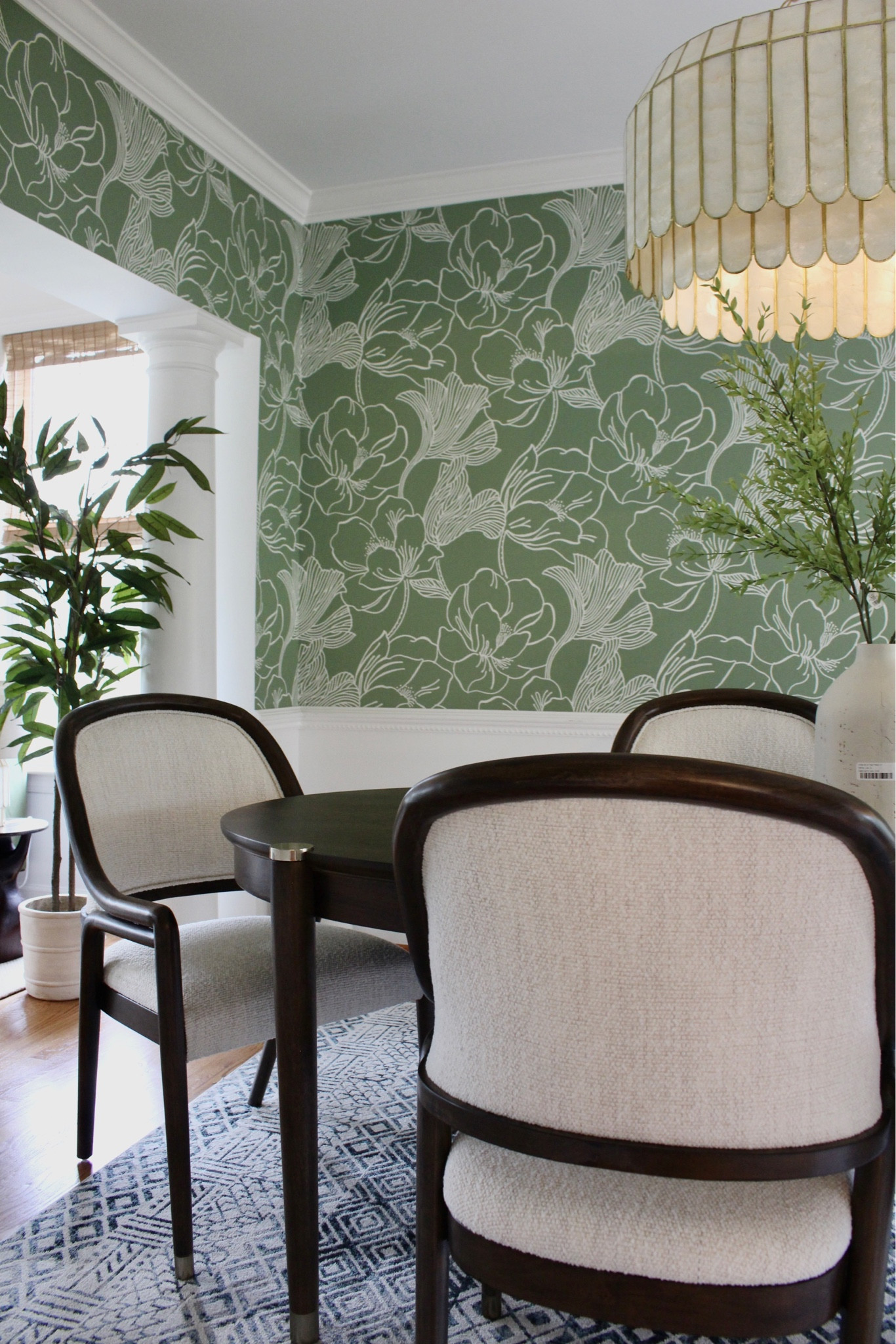 Dining room with stunning fun wallpaper, capiz pendant, and upholstered dining chairs and dark wood table 

#LTKhome #LTKunder50 #LTKunder100