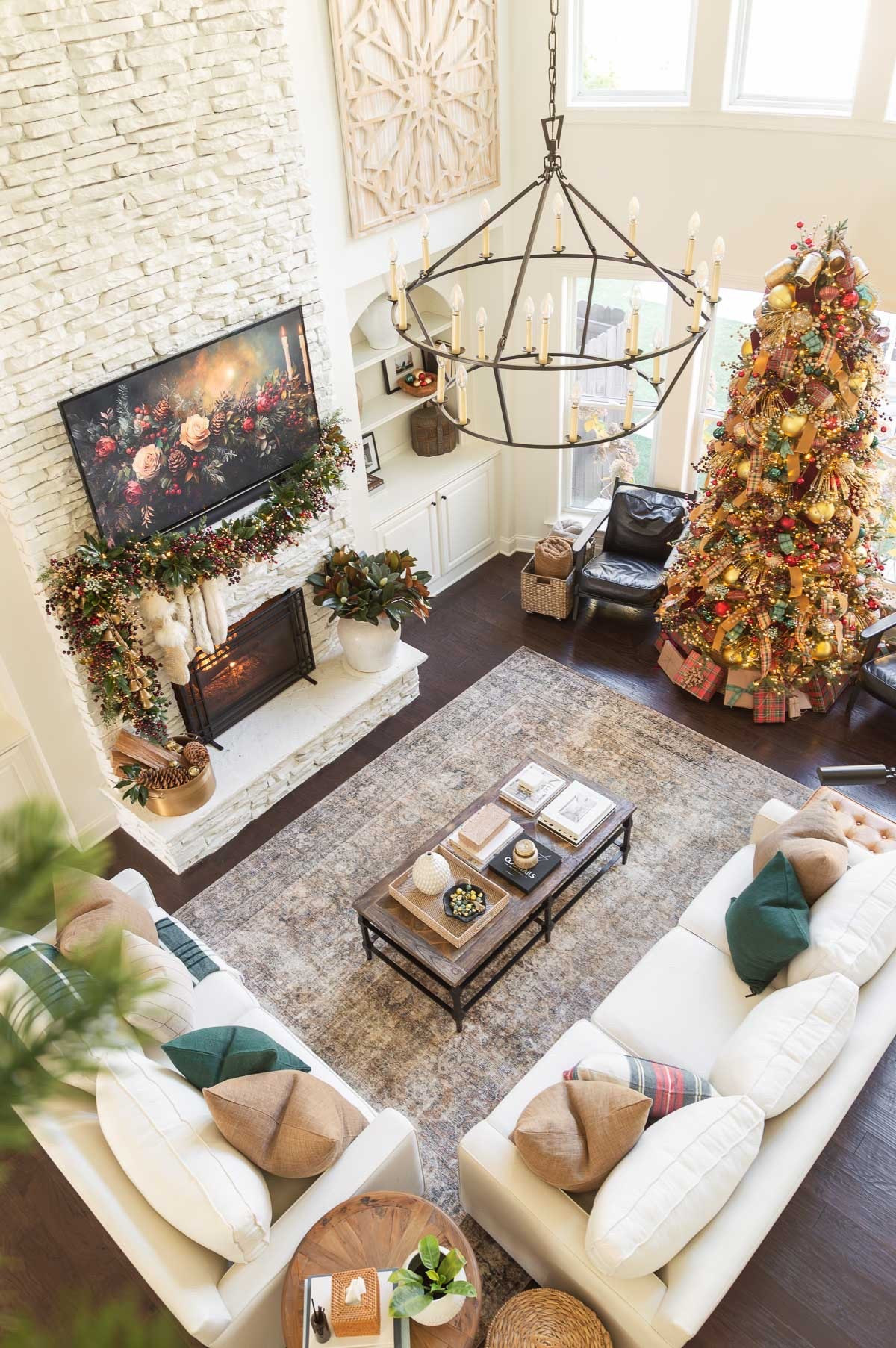 My neutral living room is dressed for the season, with pops of color, to complement the red, green and gold Christmas tree. home decor Christmas decorations area rug pottery barn sofa accent table faux magnolia branches Christmas mantel decor green pillows neutral area rug black leather chairs 

#LTKHome #LTKSeasonal #LTKHoliday