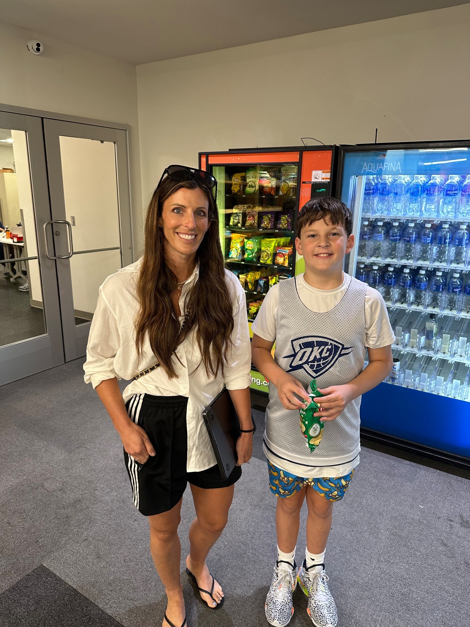 This summer we had the amazing opportunity to head to OKC Thunder Basketball Camp.  Watching little man play the sport he loves and getting to spend that time together was truly special. Such a fun few days full of hoops, hard work, and memories we’ll never forget! 

👩‍👦 Outfit details:
	•	Me: white button-down shirt, black athletic shorts with white trim, black flip flops, oversized sunglasses, casual wavy hair style, black work tote.
	•	little man:  white OKC Thunder basketball jersey, printed athletic shorts (blue/yellow pattern), white athletic socks, Nike basketball shoes, holding a green snack bag.

#OKCThunder #ThunderCamp #BasketballMom #BasketballLife #MomStyle #CasualChic #AthleticStyle #LikeToKnowIt #OOTD #BasketballKid #FamilyTime

#LTKTravel #LTKFamily #LTKKids