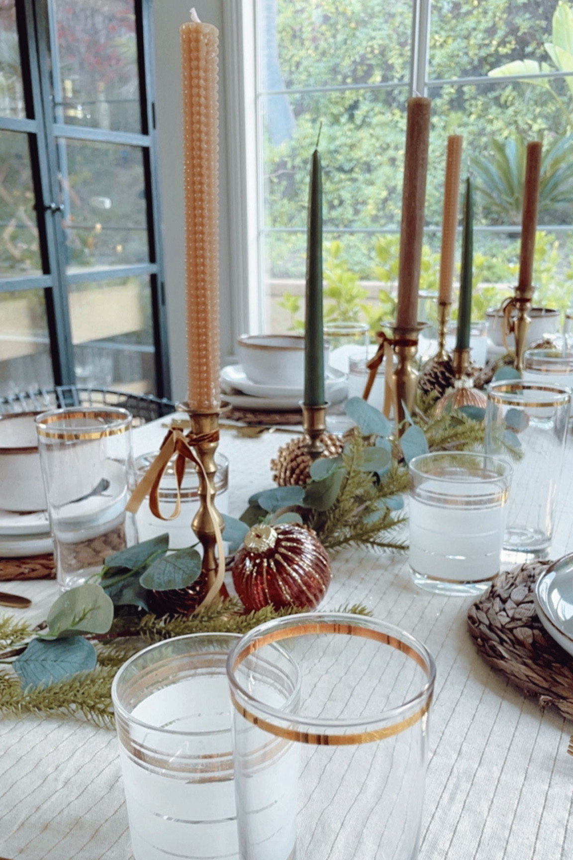 Woodland Holiday Tablescape close-up. I love the mix of the green and brown candlestick holders. Hits of gold dress up the look just enough to make it feel fancy! ✨

#LTKHome #LTKHoliday #LTKSeasonal