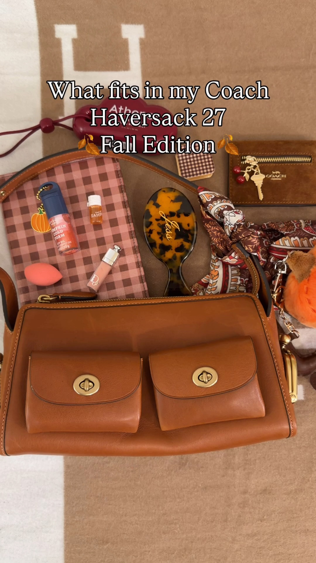 What’s in my Coach Turnlock Haversack 27 🍂Fall Edition🍂 Comment SHOP & I’ll dm you the links ♥️

What’s in my bag:
Pumpkin spice plaid kindle case
Athena love letter body spray form target 
Personalized hairbrush form Etsy
Suede Coach outlet wallet
Tula spresso eye brightening balm
Plaid mini hair clip
Bath and body works pumpkin cold foam loo gloss
Touchland pumpkin spice hand sanitizer
AirPods chain jewelry
Tom ford mini lipstick
Mini real techniques beauty blender
Dior minimal oil
Mini hair oil
Orange paisley Twilly
Pumpkin fall bag charm from American eagle