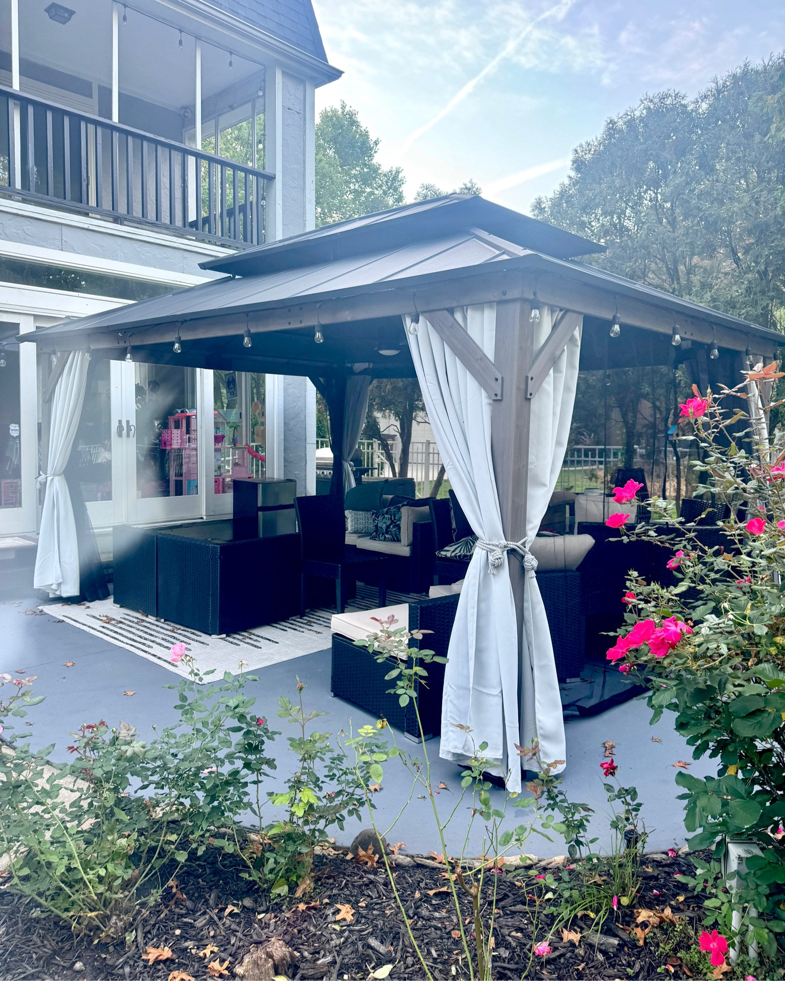 Outdoor backyard patio hardtop gazebo decor with lights, fire pit, sectional furniture and curtains.

#LTKHome #LTKSeasonal