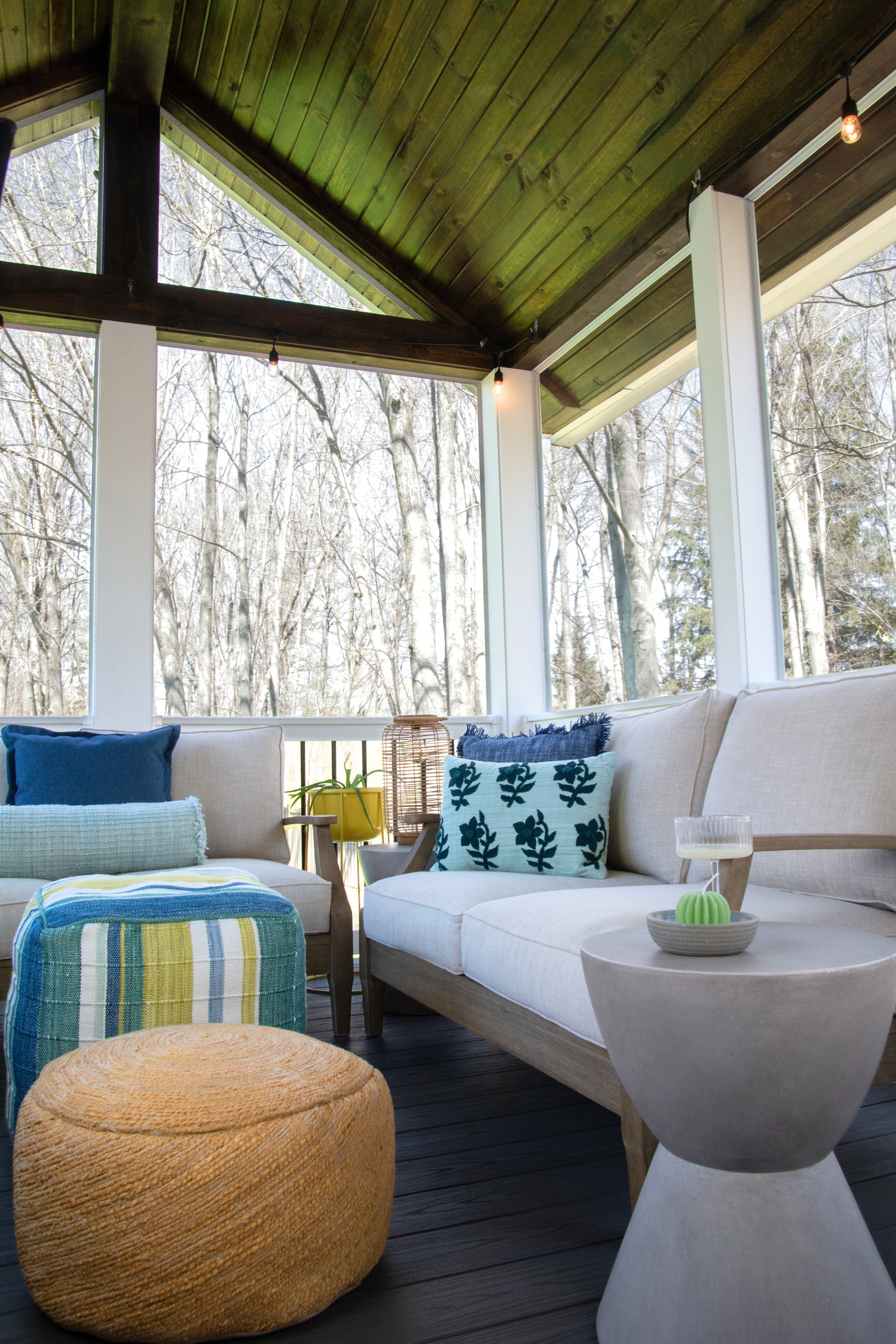 An easy porch update with colorful decor, a plant stand, and a comfortable outdoor sofa and modern outdoor furniture. #porchdecor #outdoordecor #screenedinporch #outdoorliving #cozyoutdoor #patiodecor 

 #LTKHome