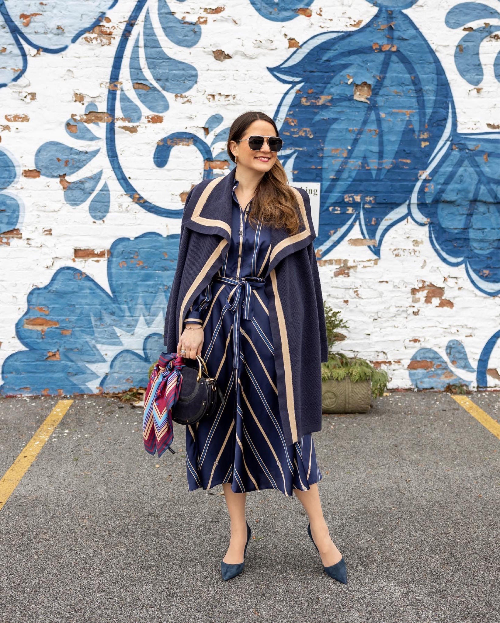 A blue and neutral stripe shirtdress with a navy and tan tipped shawl sweater and navy suede pumps from Ann Taylor paired with Amazon sunglasses and a navy suede Chloe bag

#LTKunder100 #LTKSeasonal #LTKstyletip