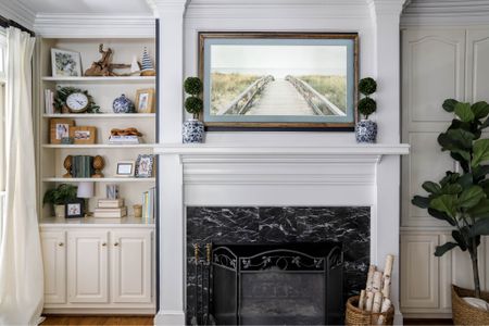 I have great fun decorating my living room bookcase. My picture frame TV sits over my mantle.

#LTKhome