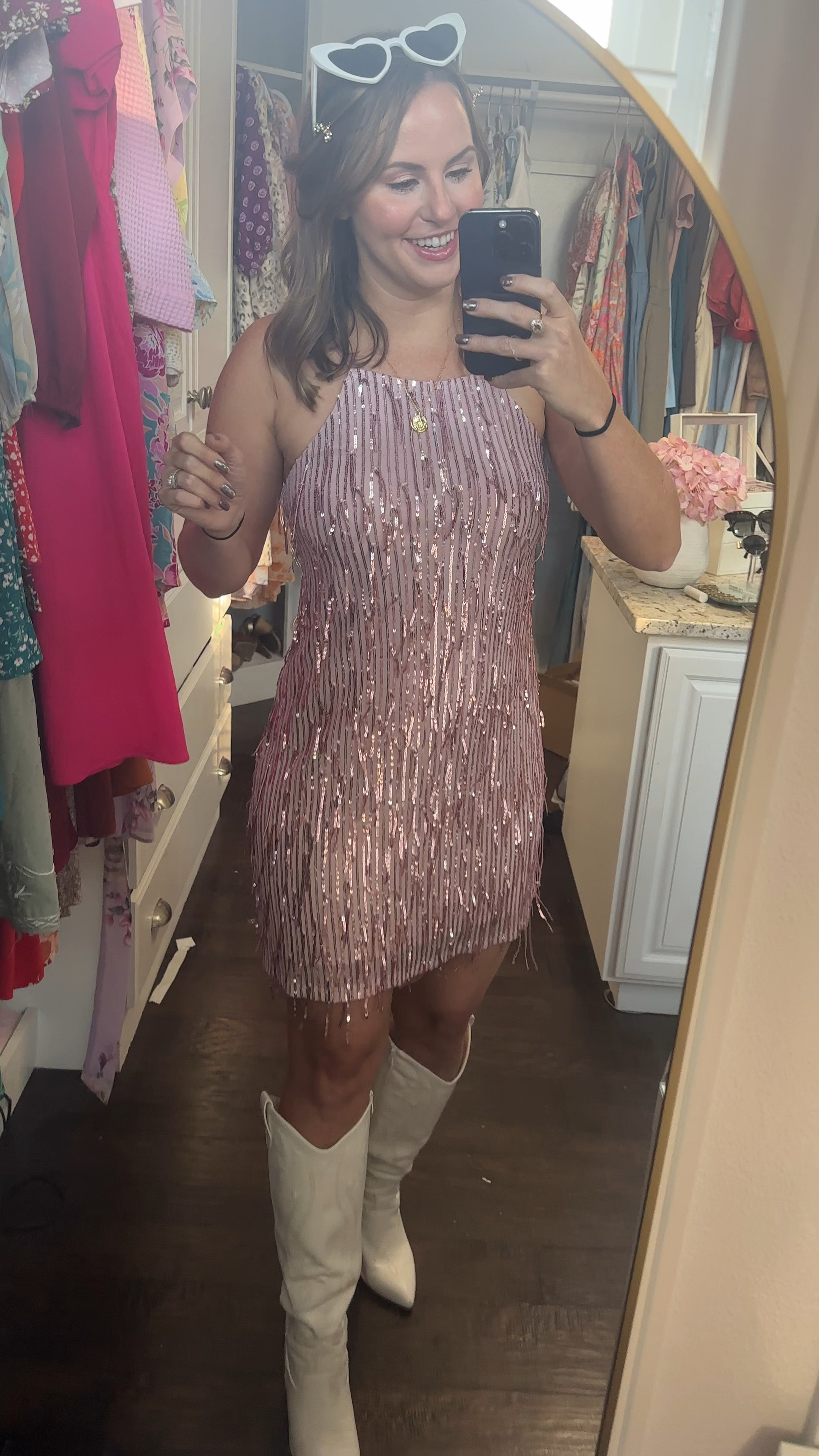 Got this fun little sparkly dress for a Meghan trainor concert & it’s under $50!!! 🎶 Paired it with white cowgirl boots, heart glasses and some sparkly hair clips. I ordered the dress in light pink and champagne to try. So hard to decide! 😻 it would be perfect for a Vegas trip, Taylor swift eras tour concert outfit, even as a Halloween costume with some go go boots or flapper costume. Too cute!!! 

Amazon fashion finds, Amazon dress, fall outfits, Home coming dress, party dress, cocktail dress, High neck shift dress, fringe dress, sparkly outfit, sparkle dress, Vegas outfit, Meghan trainor timeless tour outfit, semi formal dress

#LTKStyleTip #LTKFindsUnder50 #LTKVideo