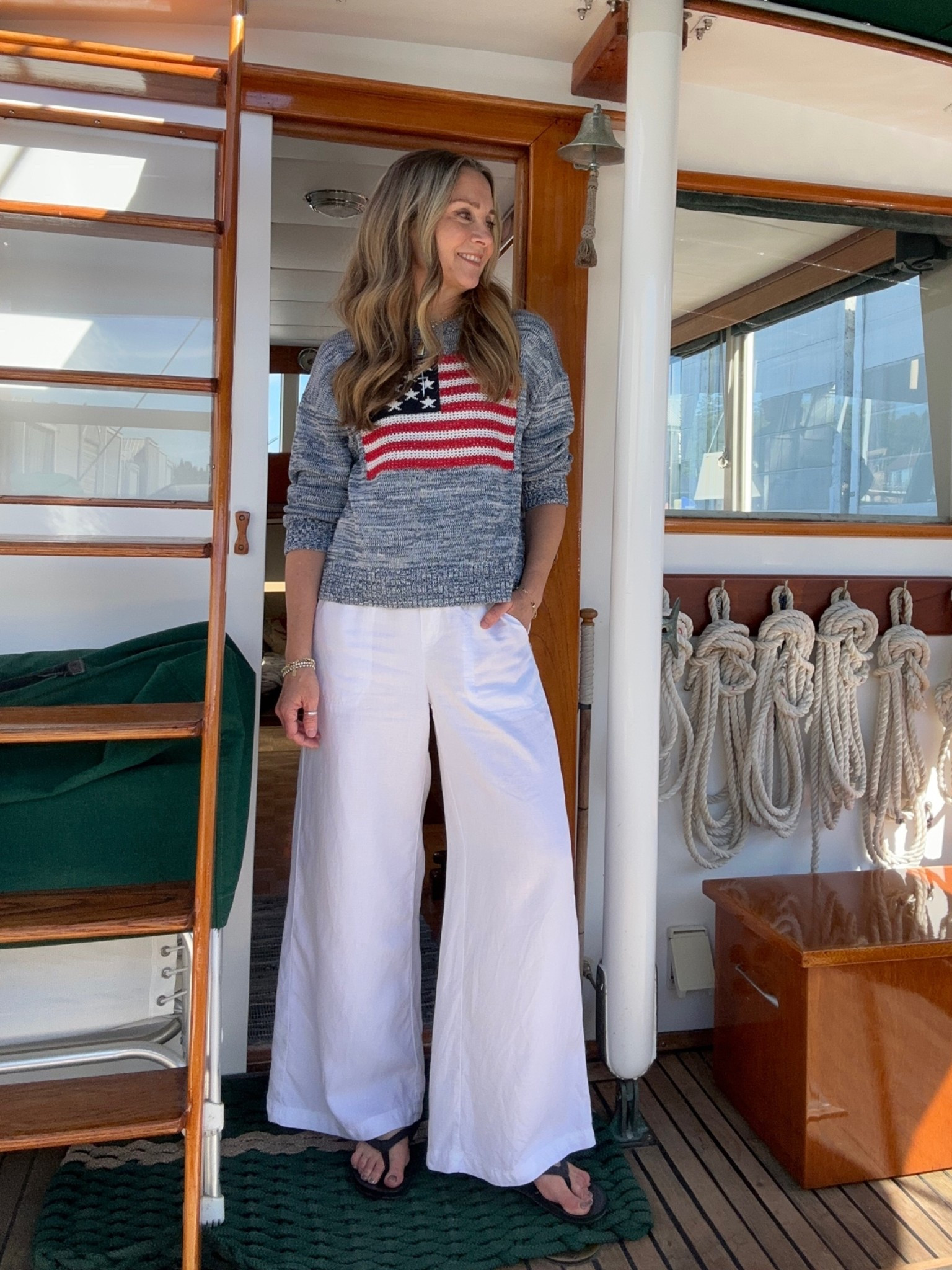 Weekend on the boat outfit! @oldnavy flag sweater with @Splendid wide leg white pants and @olukai black flip flops. Wearing small in everything, I’m 5’6”.

#LTKOver40 #LTKTravel #LTKootd