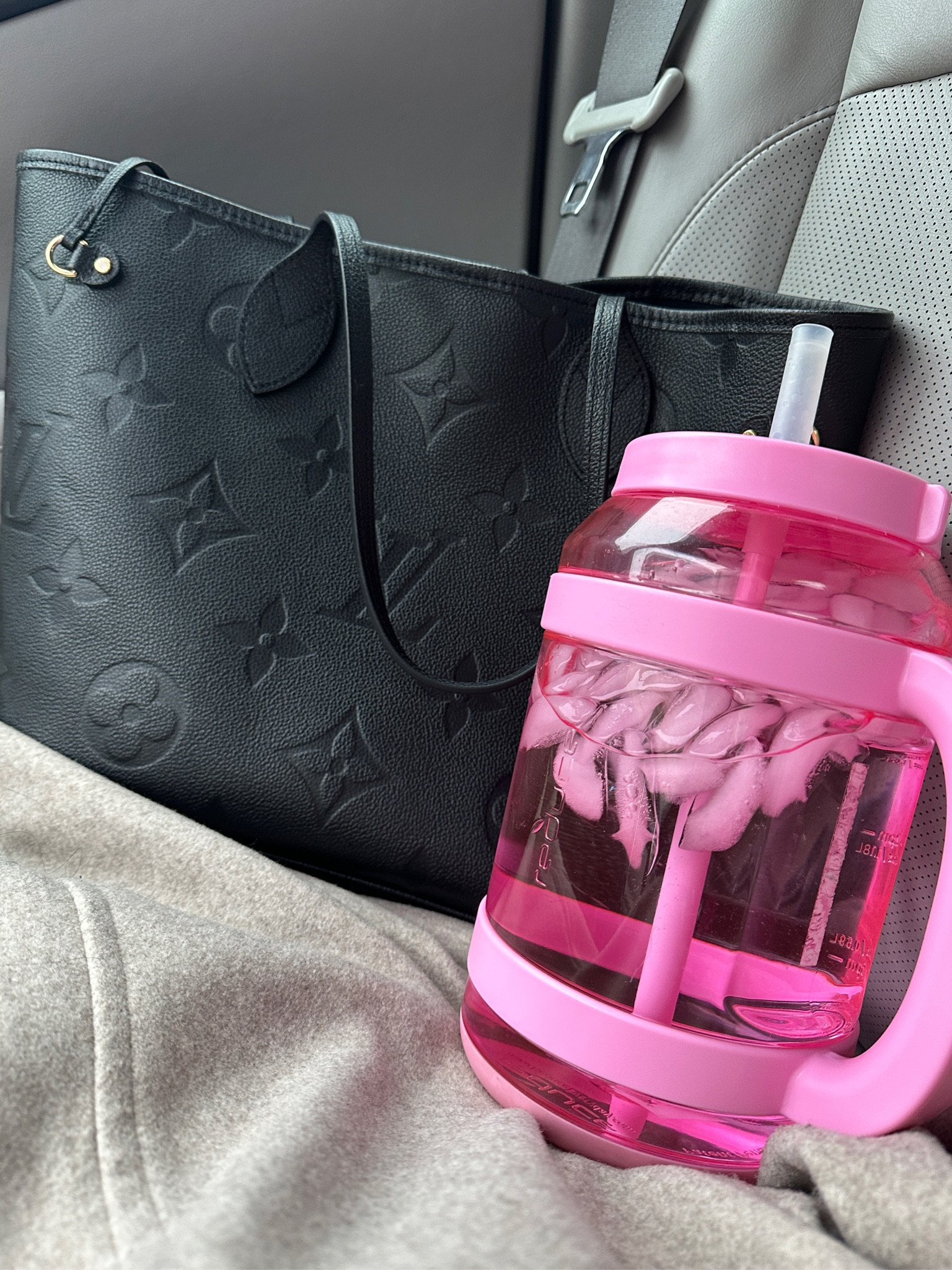 Daily Essentials.  
My Louis Vuitton Empreinte Neverfull MM is my favorite everyday work bag.  It’s lightweight and very practical.  I even love it when I’m mom-ing and don’t want to carry a diaper bag.  
Also, my pink Reduce 80oz water jug is a must have.  It has time/measurement indicators so that I can monitor how much water I’m consuming throughout the day.  

#LTKitbag #LTKMostLoved #LTKworkwear