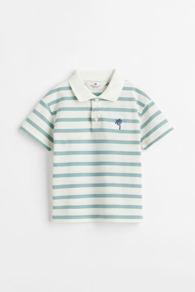 Short-sleeved polo shirt in soft cotton piqué. Ribbed collar, button placket, and an embroidered... | H&M (US + CA)