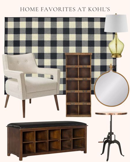 Home decor and furniture favorites at Kohl’s. Living room decor. Black and cream gingham plaid indoor outdoor area rug. Green and brass glass table lamp. Cream accent chair. Crank side table. Coffee table. Wood storage bench with black cushion. Brass round framed wall mirror. 10-cubby wooden wall cabinet. 

#LTKhome