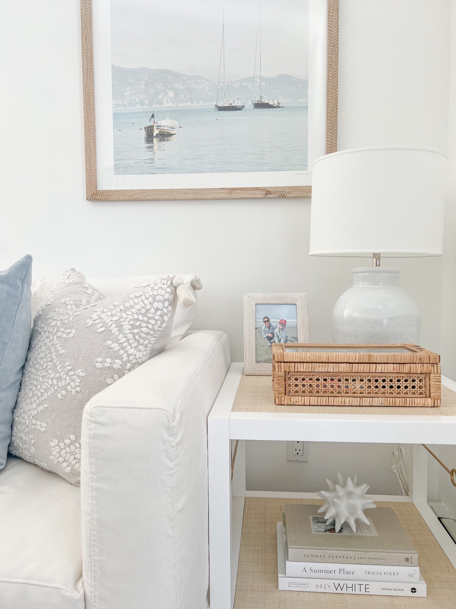 My favorite corner of my living room, with soft blues & whites, wood tones and woven accents! My side table and lamp are both 30% off today, with free shipping!
- 
coastal home decor, beach house decor, coastal living, coastal style home, coastal decor, coastal living room decor, living room ideas, white living room, neutral living room, blue & white living room, serena & lily side table, serena & living end table, cabot side table, white side tables, white furniture, white & woven furniture, blue lamps, cane boxes, decorative boxes, amazon cane box, side table decor, end table decor, living room decor, coastal art, beach art, living room art, boat artwork, amazon photo frames, amazon picture frames, amazon home accessories, coastal coffee table books, amazon coffee table books, white coffee table books, neutral coffee table books, framed artwork, pillow styling, serena & lily pillow covers, blue velvet pillow cover, spring pillow covers, white couch, white sofa, slipcover sofa

#LTKHome #LTKCyberWeek #LTKSaleAlert