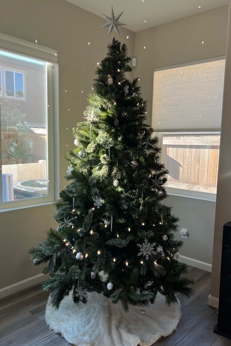 My 2022 Christmas tree with a silver and white theme, featuring disco ball ornaments, snowflake ornaments, icicle ornaments, bright white LED lights, and a white faux fur tree skirt

#LTKSeasonal #LTKHoliday #LTKhome