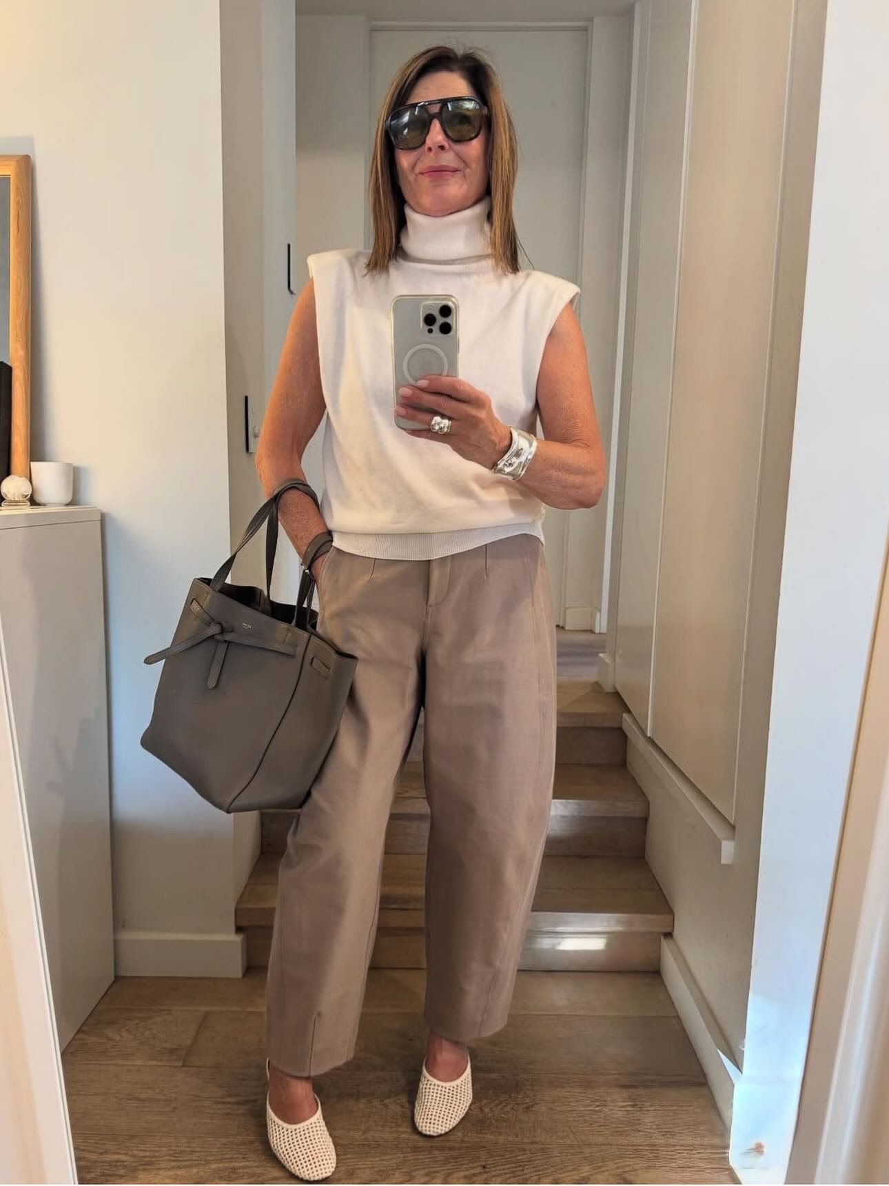 What pieces am I rewearing again this summer? 

Beige pants and a white sleeveless knit. 
Both still right again this season !
Both classics updated into new shapes .

The beige pants ( old @lululemonausnz ) feel so modern with a barrel leg and a high waist. 
The cream poloneck knit @thefrankieshop has shoulders pads so feels sharper, looks cool.
Shop similar right here !

#LTKaustralia #LTKover50style #LTKstyletip