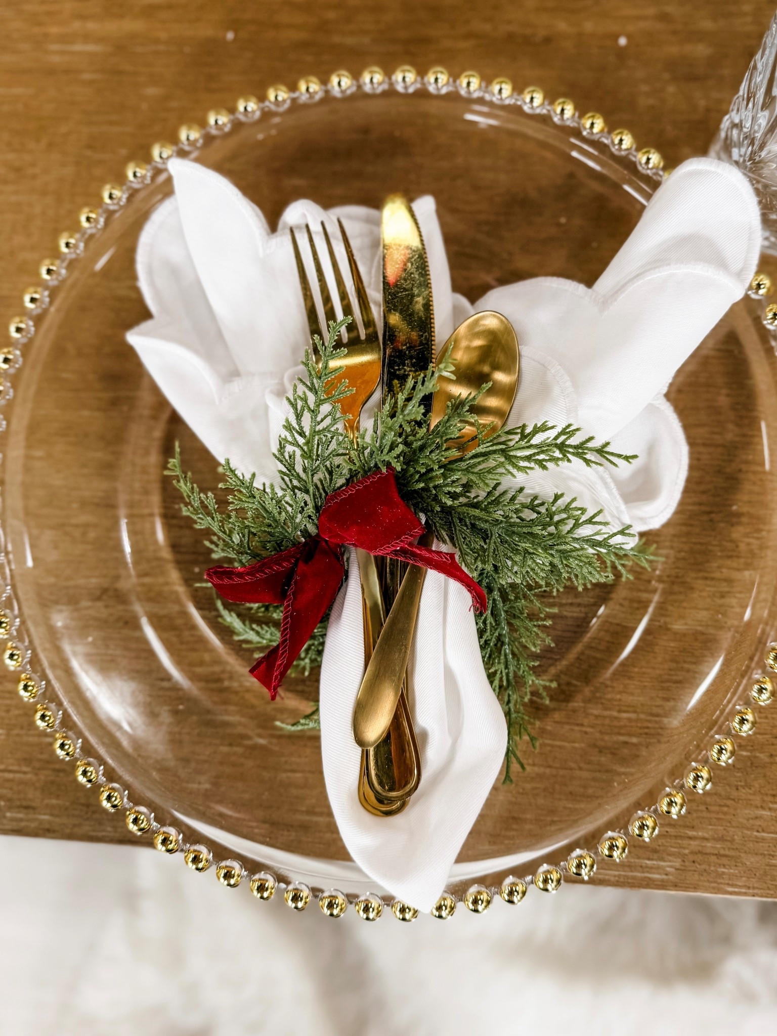 Holiday hosting made easy ✨
Sharing this festive place setting of 4—glass chargers, wreath napkin holders with velvet bow, and scalloped cloth napkins - for a look that’s polished, timeless, and on clearance. Everything you need to recreate a festive and elegant table. .

#HolidayTable #TablescapeInspo #FestiveStyle 

#LTKParties #LTKHome #LTKSeasonal