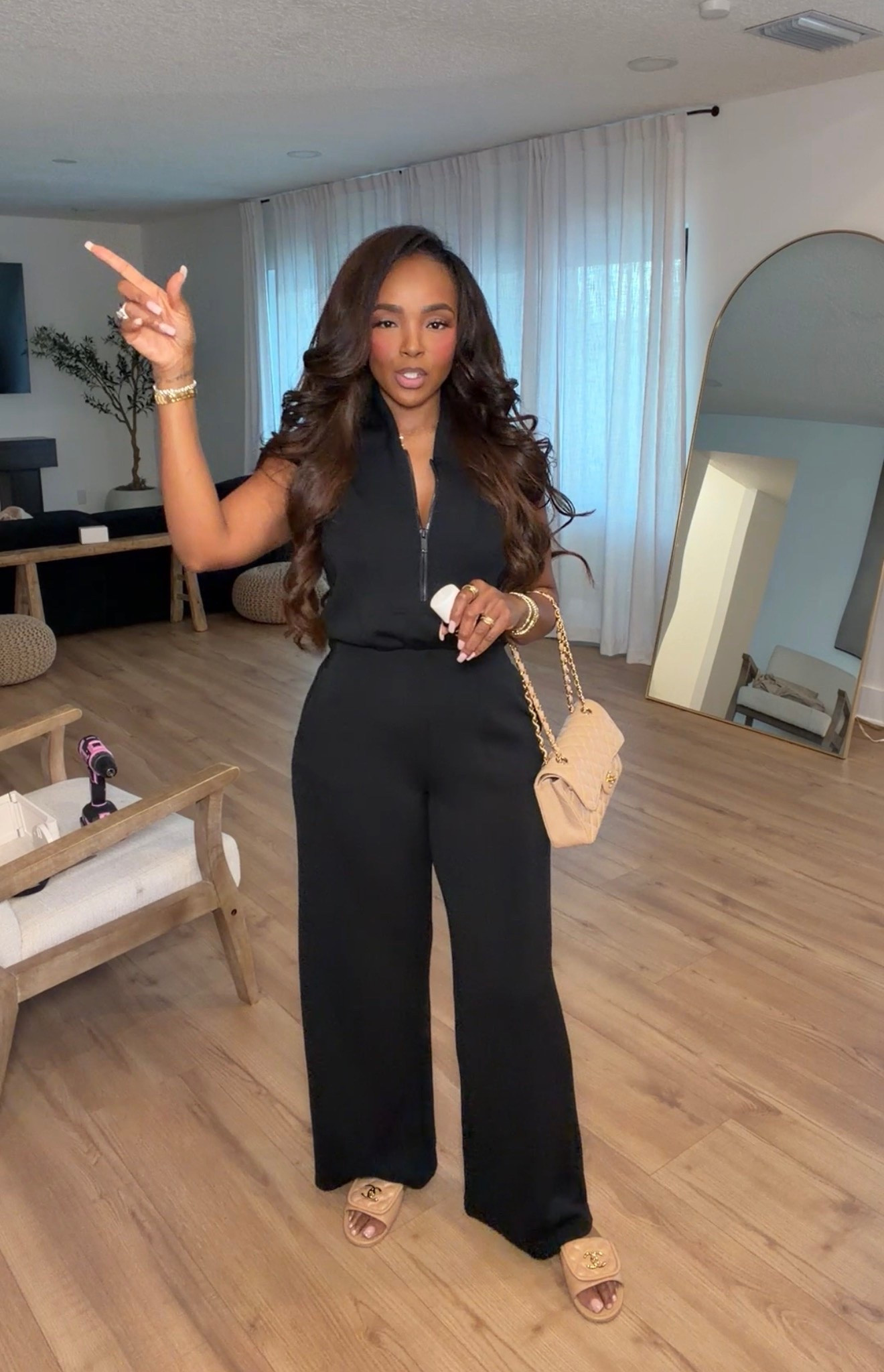 A moment of calm in a busy room—simple lines help keep things steady. Wearing the black jumpsuit, the fabric holds a quiet strength. Stay grounded with small shifts. #LTKselfcare