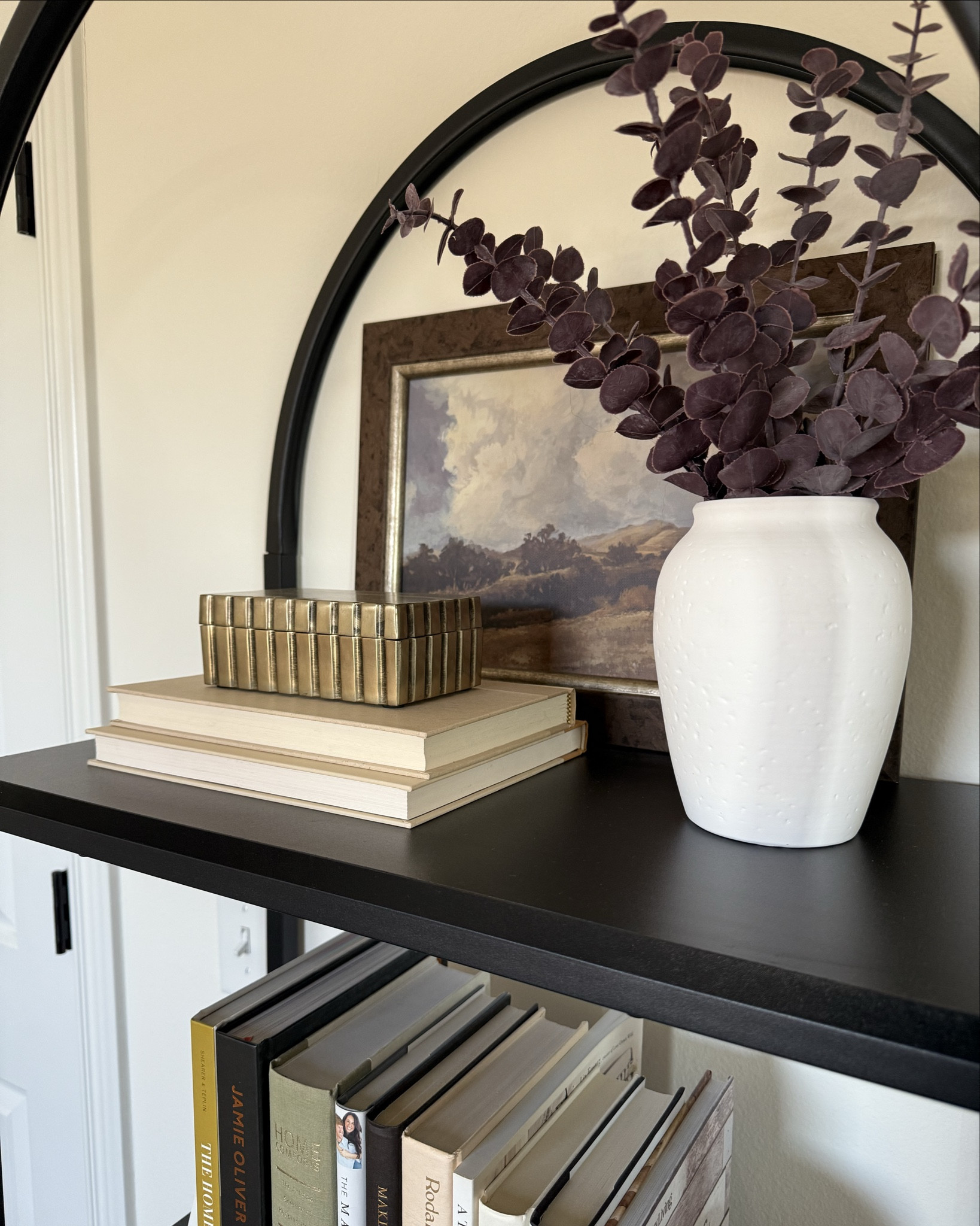 Styling this arched shelf is one of my favorite ways to add personality and warmth to a small wall. The curved top already makes a statement, so I like to keep the decor balanced and intentional—mixing books, textured boxes, and sculptural pieces to create layers without making it feel cluttered.

And before you buy anything new, shop your home for pieces you already love. Moving decor from one room to another is such an easy (and free) way to refresh a space and make it feel styled with intention ✨

#LTKHome