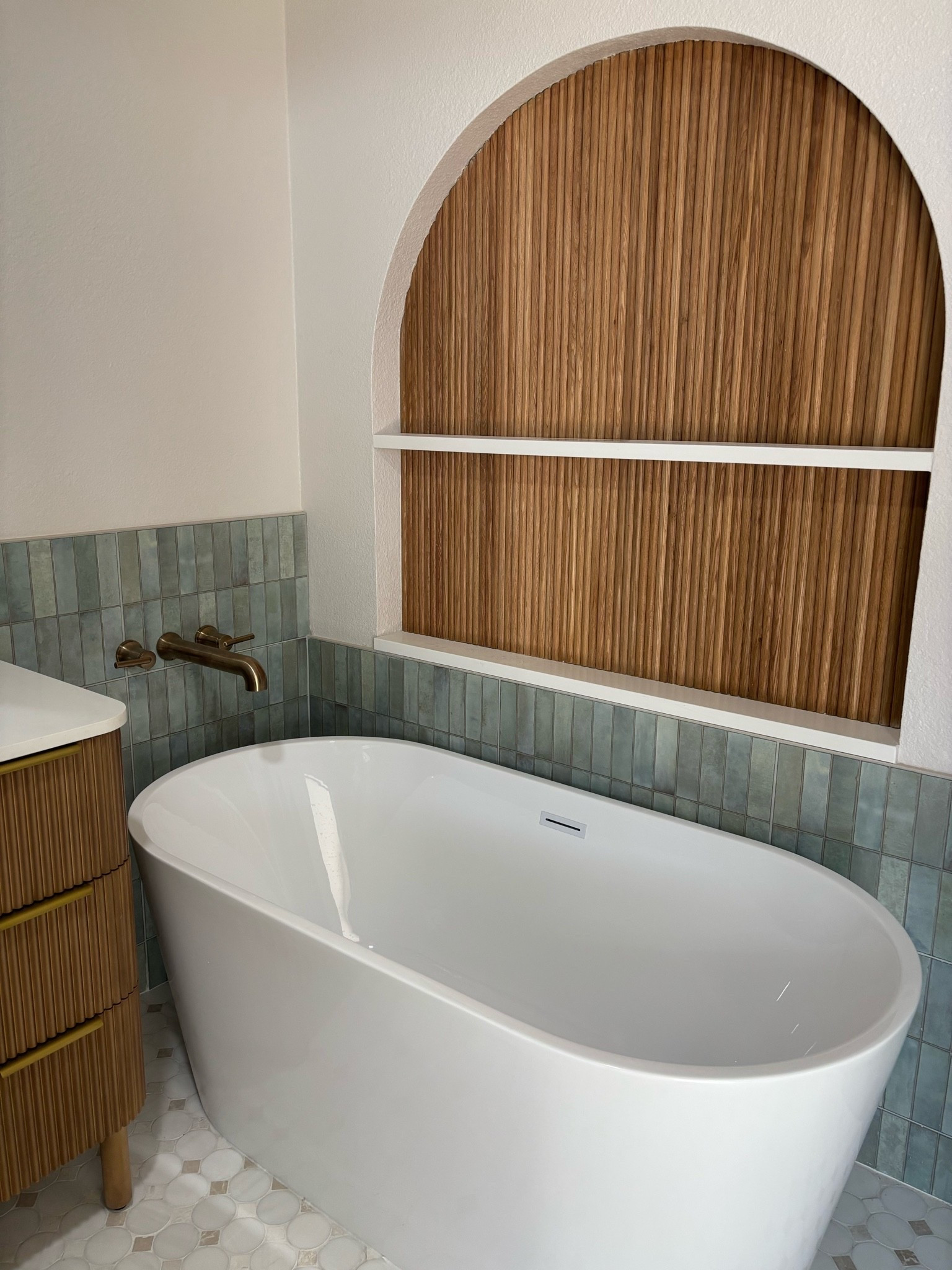 A tub that was on sale at Wayfair and this beautiful custom niche above it with paneling also from Wayfair

#LTKHome
