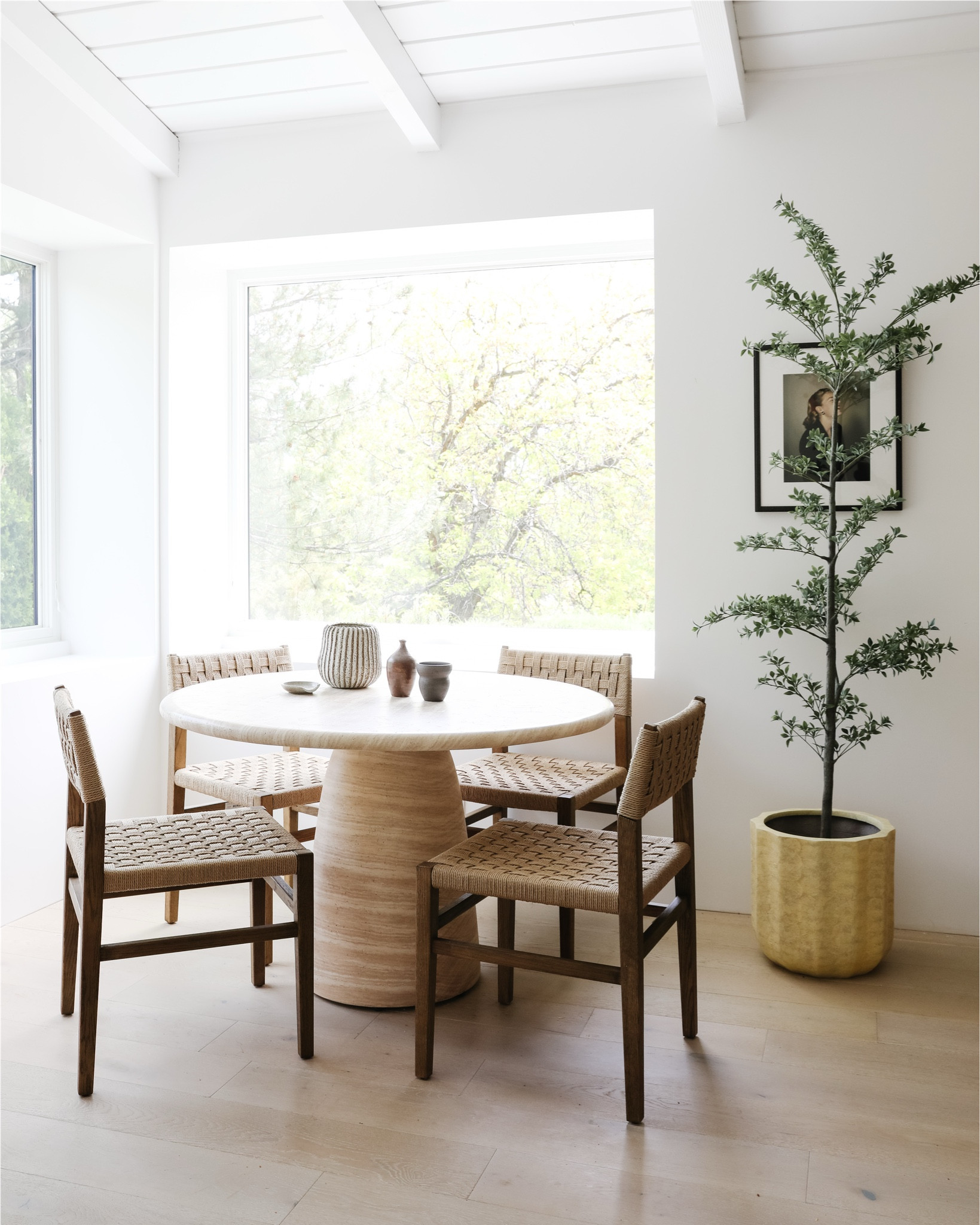 Our breakfast nook is one of my favorite spots in the house! The morning light is so lovely when we sit here to drink coffee. The table is just the right size at 46” diameter, and the travertine texture is really subtle and adds so much warmth. The chairs are sturdy and comfortable and the smoky oak finish adds a touch of contrast without being *too* dark. And the faux black olive tree is a nice touch of architectural greenery! #diningroom #neutralhome #potterybarn

#LTKHome #LTKFamily #LTKStyleTip