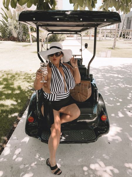 Striking a pose in my timeless black and white striped swimsuit, an ode to classic elegance with a modern twist. The suit's bold stripes perfectly contour my silhouette, creating an eye-catching contrast that's both bold and sophisticated. I've paired it with a chic white floppy hat, its broad brim not only shielding me from the sun's kiss but also adding a touch of Hollywood glamour to my look. Completing this ensemble is a sleek black sheer coverup, flowing effortlessly with every step I take, its translucent fabric playing a flirtatious game of reveal and conceal with the sun's rays. This outfit isn't just swimwear, it's a confidence booster, turning the beach into my runway. Whether I'm lounging by the pool or strolling along the shore, this ensemble ensures I do it with style and grace. It's the perfect attire for making lasting vacation memories, where every moment feels like a scene from a glamorous movie. #BeachGlam #StripedSwimwear #VacationVibes #PoolsideChic #HatGameStrong #BlackAndWhiteFashion #SheerElegance #SummerStyle #FashionistaTravel #SwimwearGoals #BeachwearBeauty #ElegantSwimsuit #TrendyTravels #GlamourSunshine #ChicCoverups #resortwear #blackandwhite #swimsuit 

#LTKplussize #LTKstyletip #LTKtravel