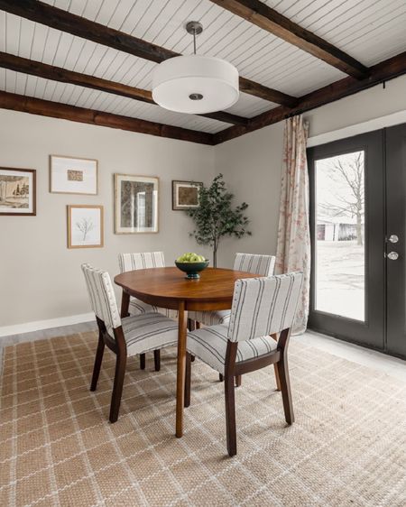 Keeping the beams a dark wood really brings the dining space together .

#LTKhome