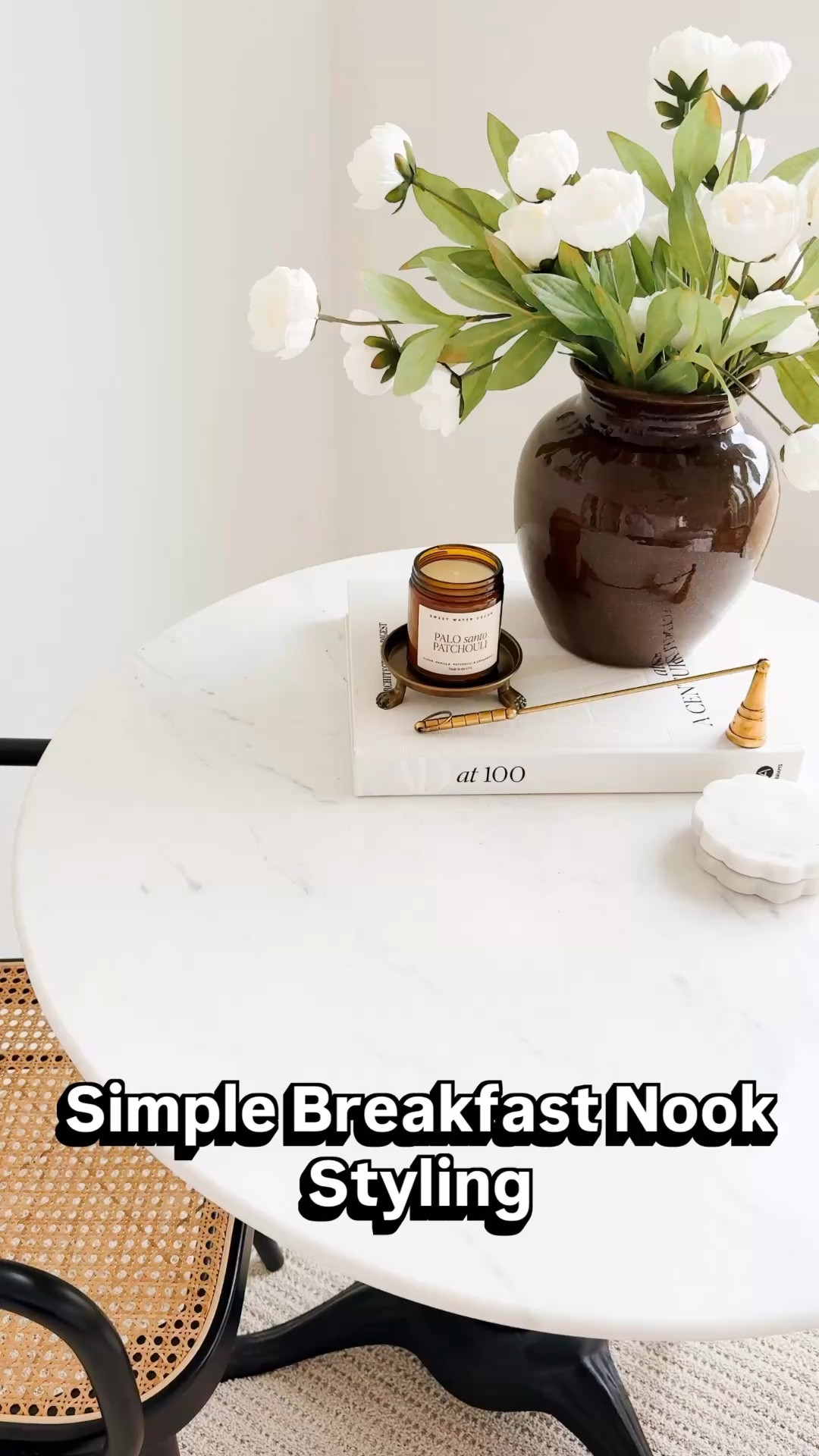 Simple breakfast nook styling that makes this little corner feel cozy and elevated. I layered a marble bistro table with neutral decor including faux florals, a ceramic vase, candle, and a few favorite styling pieces to create an effortless everyday look. My Pottery Barn bistro table is currently on sale and I found similar cane  cafe chairs as well as several affordable Amazon decor pieces to recreate the look. If you love neutral home decor and small space styling, this is such an easy way to elevate a breakfast nook, coffee corner, or dining space. Follow me on LTK for daily fashion, home decor & Amazon finds. Breakfast nook decor ideas, bistro table styling, neutral home decor, small dining space decor, cozy home inspiration, marble bistro table, modern neutral home styling.

#LTKHome #LTKSeasonal #LTKvlog