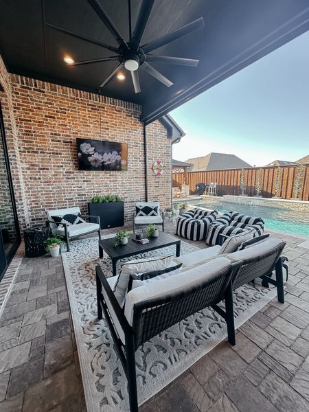 Backyard patio. Outdoor furniture. Black and white patio. Outdoor indoor rug. Backyard vibes for summer! #outdoorfurniture #patio

#LTKhome #LTKfindsunder100 #LTKsalealert