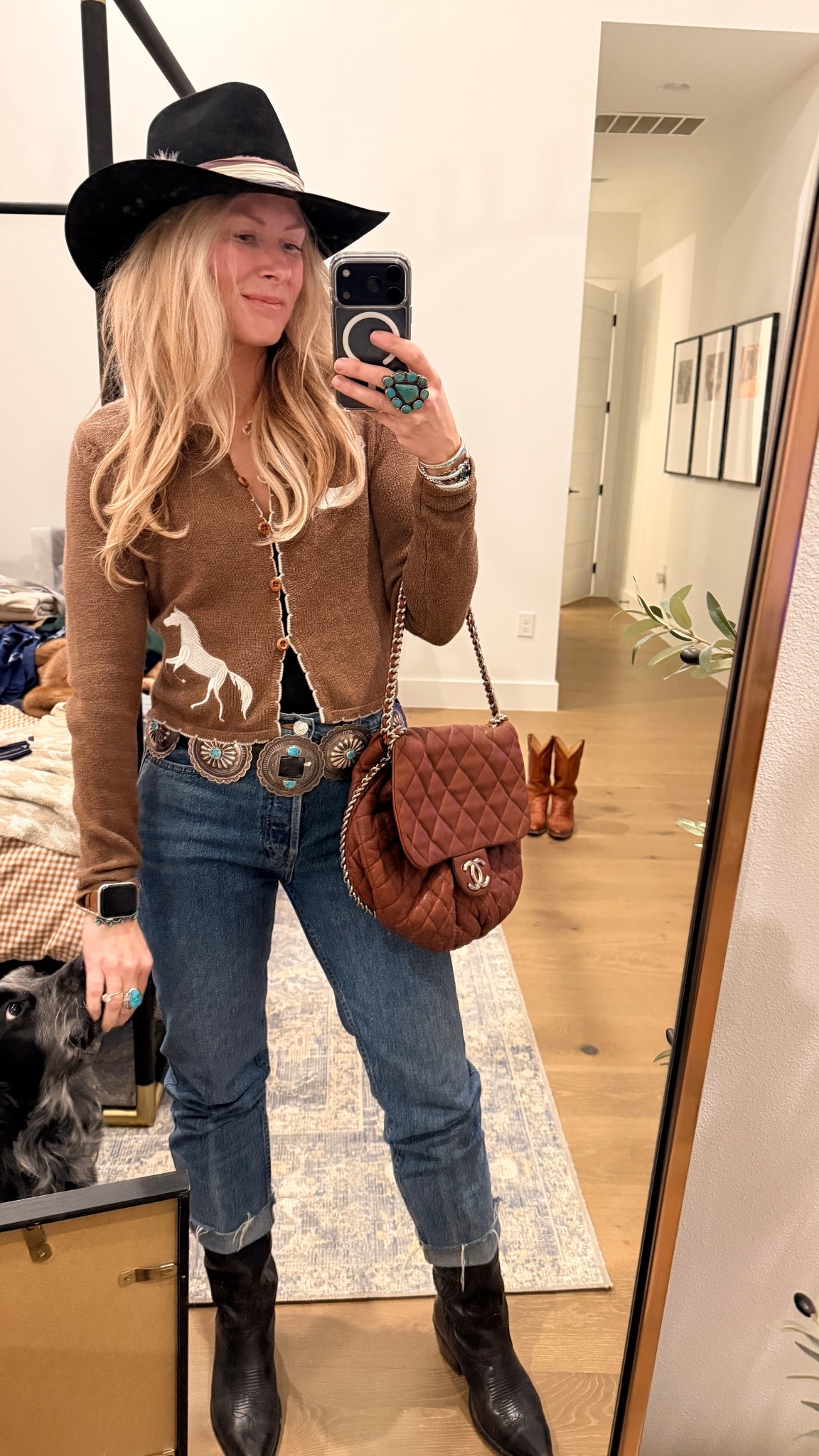 Country concert outfit for the winter when you don’t feel like sparkles! Another Girl embroidered horse sweater with stove pipe Re/Done jeans and my black Annie Tecovas 