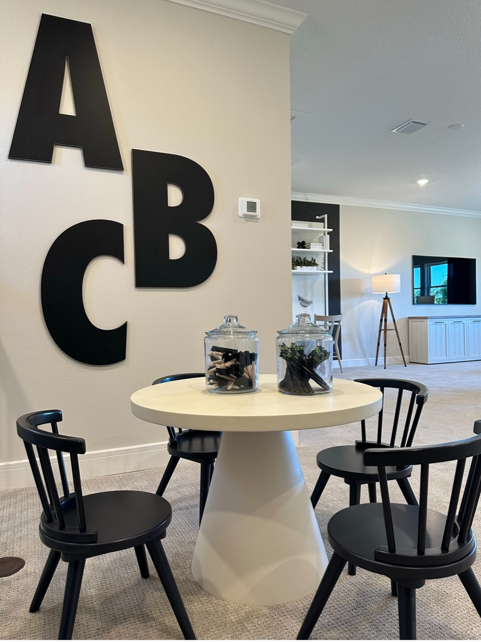 A multi purpose room with a kids corner. TABLchairs and large ABC letters

#LTKkids #LTKhome