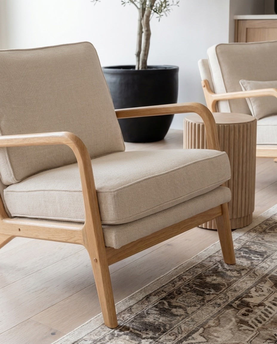 Shop the Look:
• Fluted light-oak coffee table
• Cream textured curved sofa
• Chunky knit throw in warm beige
• Neutral linen accent pillows
• Light wood armchairs with cream cushions
• Marble fireplace surround panel
• Round glass pendant light
• Woven natural pouf stools
• Fluted wood side tables
• Vintage-inspired neutral area rug
• Potted faux olive tree

#LTKFindsUnder100 #LTKSaleAlert #LTKHome