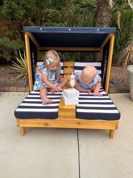 KidKraft Wooden Outdoor Double Chaise Lounge with Cup Holders. The Cutest Kid's Patio Furniture. It Comes In Honey with Navy and White Striped Fabric. 

#LTKKids #LTKBaby #LTKParties