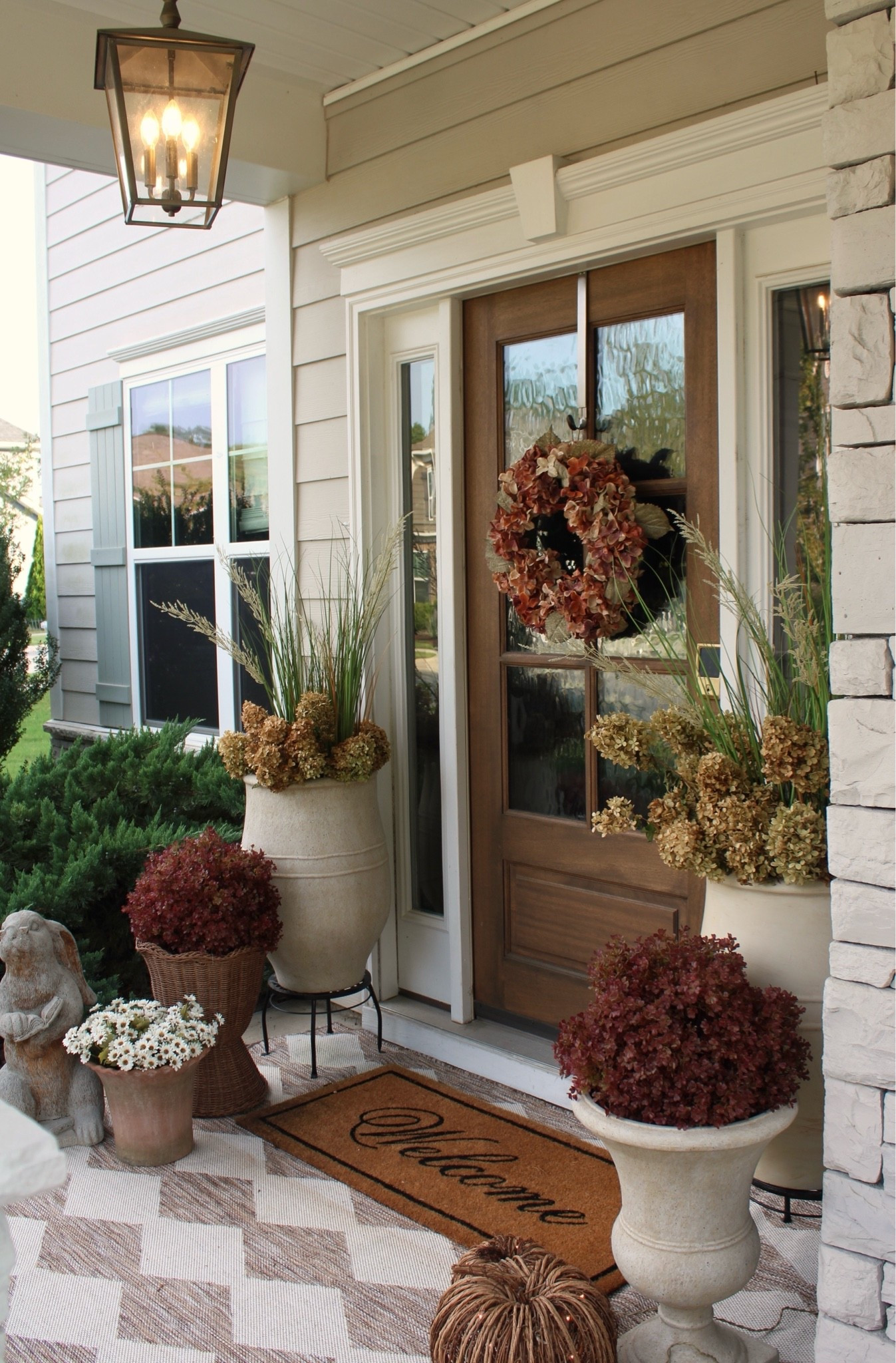 Fall front porch, front porch styling, fall decorating, fall wreath, front door, porch ideas, outdoor rug, planters, faux mums, outdoor florals

#LTKHome