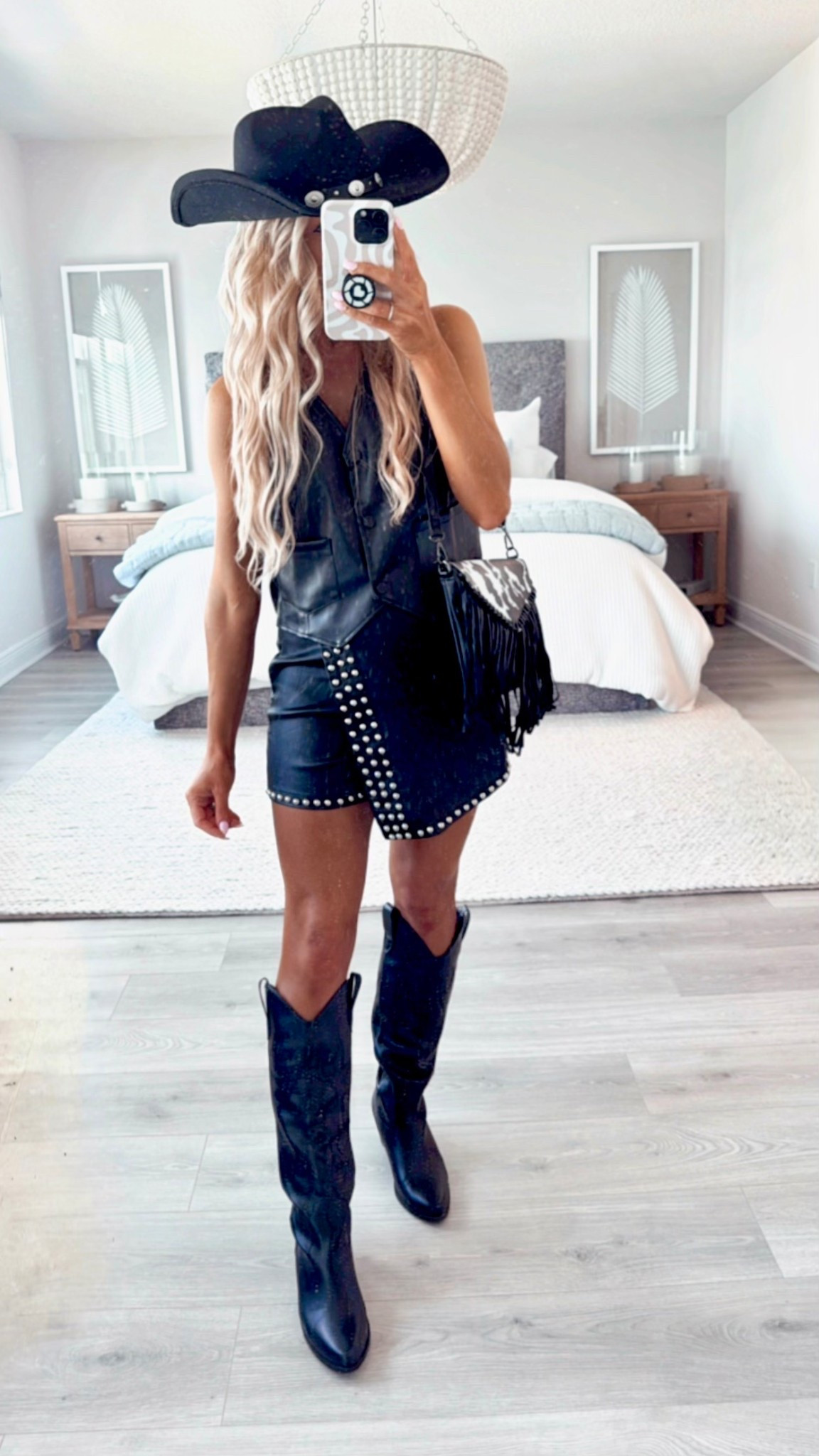 COUNTRY CONCERT OUTFIT!

This western styled country concert outfit + cowgirl boots are perfect for your next concert, music festival, rodeo, Nashville trip, or bachelorette party!

The black leather vest, black cowgirl boots, cowgirl hat, + black leather studded mini skort makes a trendy concert outfit.

#LTKStyleTip #LTKParties #LTKSeasonal
