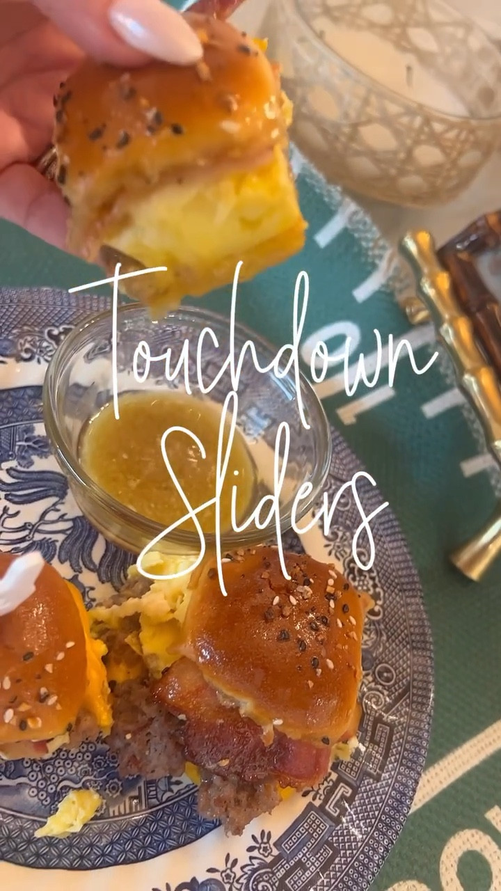 Touchdown Sliders
(6 ingredients for the touchdown then the extra point on top)

2 packages of Hawaiian rolls (sliced sideways on baking dish)
Sliced cheese (American or cheddar) 
1 lb sausage (cooked and drained) 
8 eggs scrambled 
Swiss cheese 
1 lb cooked bacon 

Layer the items above and place the top of the rolls back on top.  Now, for the extra point…

Melt 1 stick of butter 
3/4 cup of maple syrup 
Mix together and brush the top of the rolls with it. 
Sprinkle @traderjoes everything bagel seasoning on top. 

Bake at 375 degrees for 10 minutes until toasted and melting around the edges.  Cut with a sharp knife and use the remaining sauce for dipping. 

#LTKFamily #LTKParties #LTKU