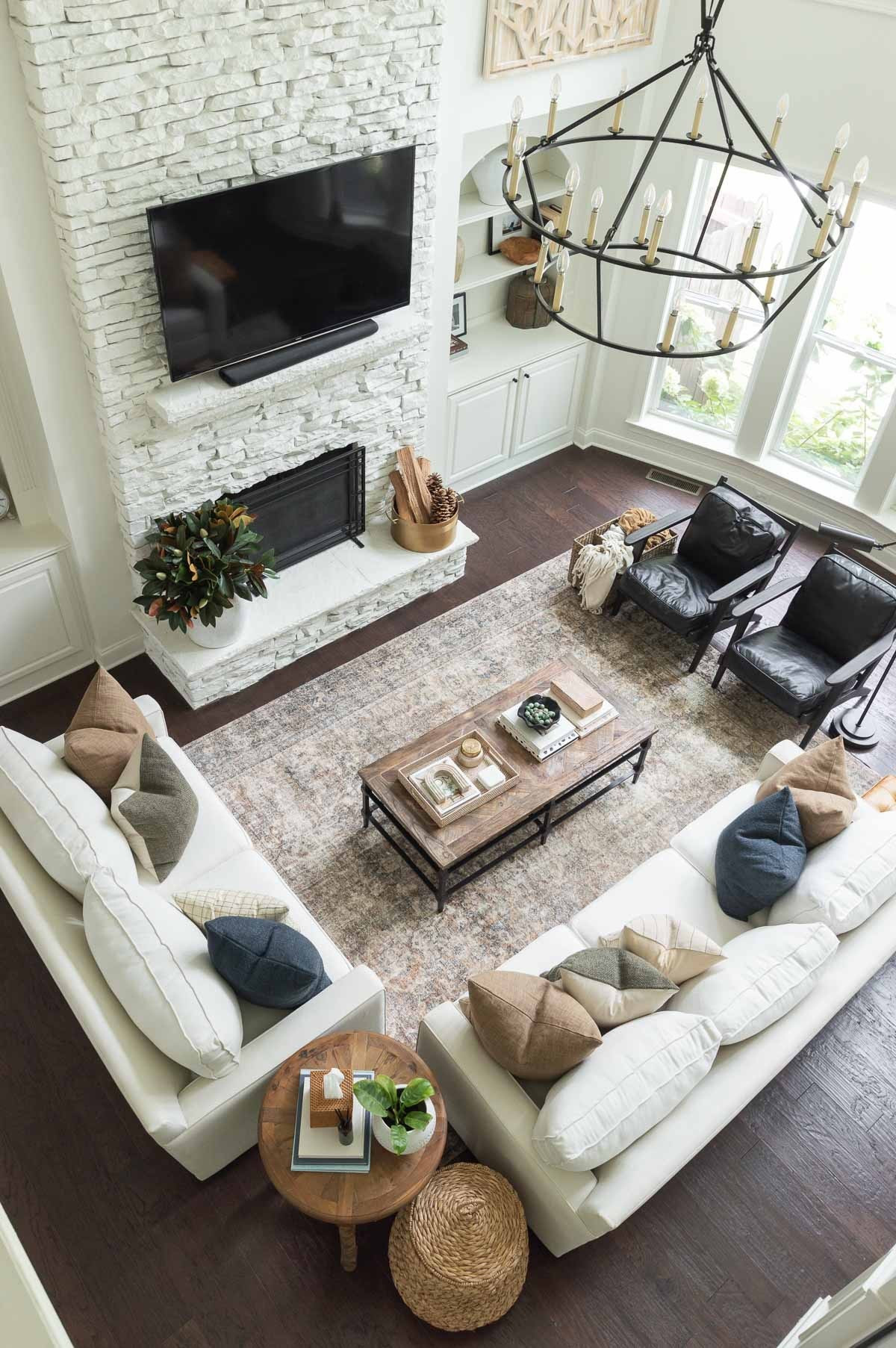 Cooler temps called for adding some simple winter touches to my living room, including new dark blue and striped pillows. I can’t wait to add a pumpkin or too after we visit the pumpkin patch! home decor neutral decor fall decor living room decor area rug iron chandelier #LTKStyleTip 

#LTKHome #LTKSeasonal