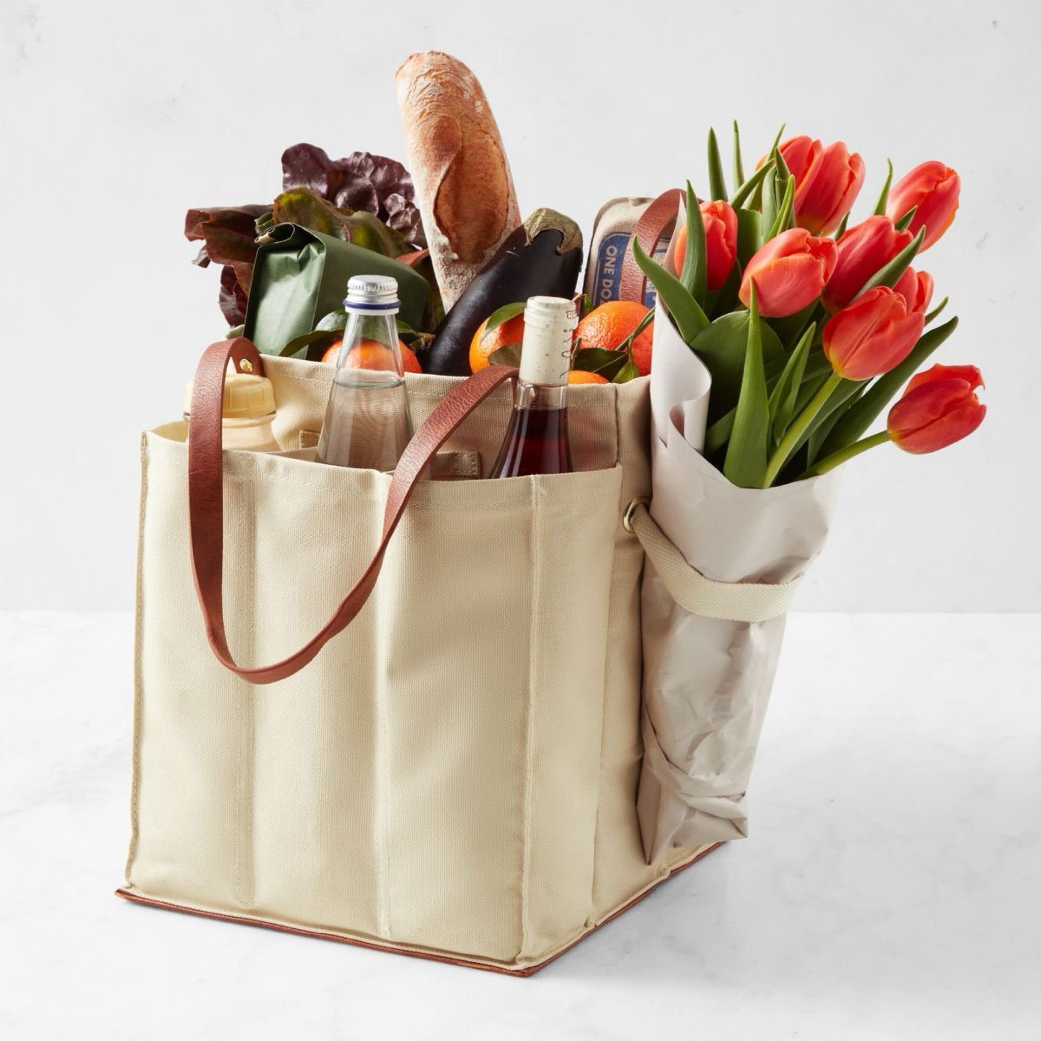 Just adding some things that are in my wishlist recently. This market tore caught my eye! A section for flowers separating wine and more! Hurry quantities are limited! Adding some dupes to this as well!

Carry vegetables, eggs, fresh flowers and more in these heavy-duty cotton canvas totes thoughtfully designed for trips to the farmers' market or your neighborhood grocery store – or for harvesting your own homegrown bounty. The Market Tote features dividers to keep delicate produce separated and protected from bottles and containers, and a cinch strap on the outside secures a bouquet, ensuring wet stems won't drip inside your bag. Reinforced base to help it stand unsupported and upright while shopping or driving home from market.

Made from heavy-duty cotton canvas.
Vegan leather straps and base.
Six outer compartments, three on each side; an external canvas strap securely holds a bouquet.
Designed to stand on their own and stay upright in the car.

#LTKSeasonal #LTKfindsunder50 #LTKhome