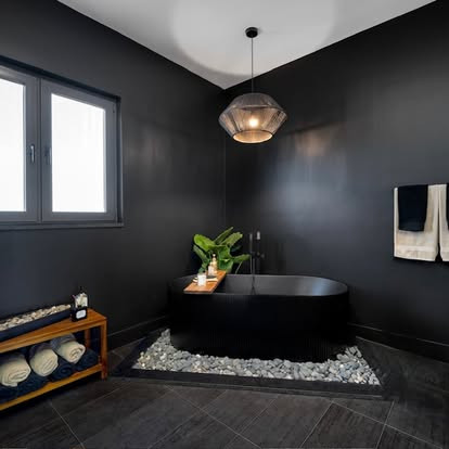 Soak, unwind, and escape. 🛁🌿

This statement tub becomes the heart of the space—surrounded by moody black finishes and warm dark wood for a perfectly balanced, spa-like retreat. Every detail is designed to invite relaxation and elevate everyday rituals.

Your sanctuary starts here.

#BathroomDesign #SpaVibes #LuxuryBathroom #ModernDesign #TubGoals #InteriorInspo #DesignByRania 

 #LTKHome