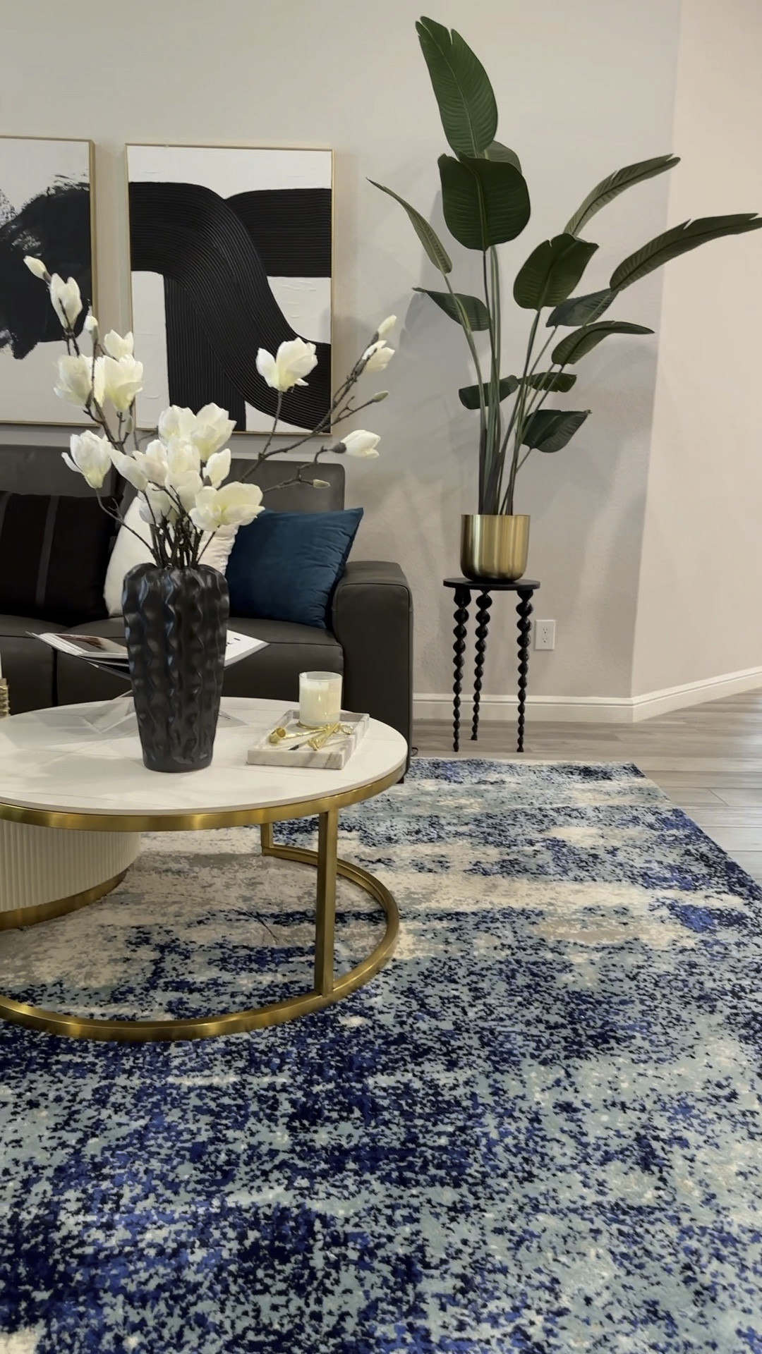 Modern glam living room makeover, pop of color, neutral, living room decor, teal living room decor, luxury, living room ideas, luxury, coffee table, marble coffee table, gold coffee table, neutral, modern art, luxury pillows, modern rug, faux tree, tree stand, modern decor, modern black sideboard, black accents