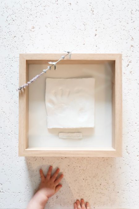 Want to give mom or grandma something priceless?  This easy DIY gift is perfect for those who have a young child.  It's a framed clay hand and footprint of their child/grandchild that will be a keepsake forever!  A natural and neutral aesthetic, perfect for everyone.

Start off by rolling the clay.  You want it to be thick enough so that the footprint doesn't come out on the other side, but not too thick as to be too heavy for the glue once it's set in the frame.  The size of the clay perimeter should be smaller than the frame backing - this is  to your liking, but for me, I like having a larger frame, so I made the clay perimeter as small as possible.  Be sure to also leave room for the name tag which goes below the clay footprint/handprint.
Have your child stamp their handprint/footprint  on the clay.  For younger children, you may need another set of hands to help you steady their foot/hand.
Set aside the clay piece and grab a small scrap piece of clay and roll it out about the same thickness as the main clay piece.  Stamp your clay with the little one's name, and cut around the name to create a tag.
Let the clay dry!  I let mine sit for 12 hours, but there are clays that dry very fast so you don't need to wait that long!
Once the clay has dried, take your glue and glue it to the backing of the shadow frame.
After the glue has set, put it in the frame and you're done!  A perfect gift for a loved one in no time!


#LTKunder50 #LTKbaby #LTKGiftGuide