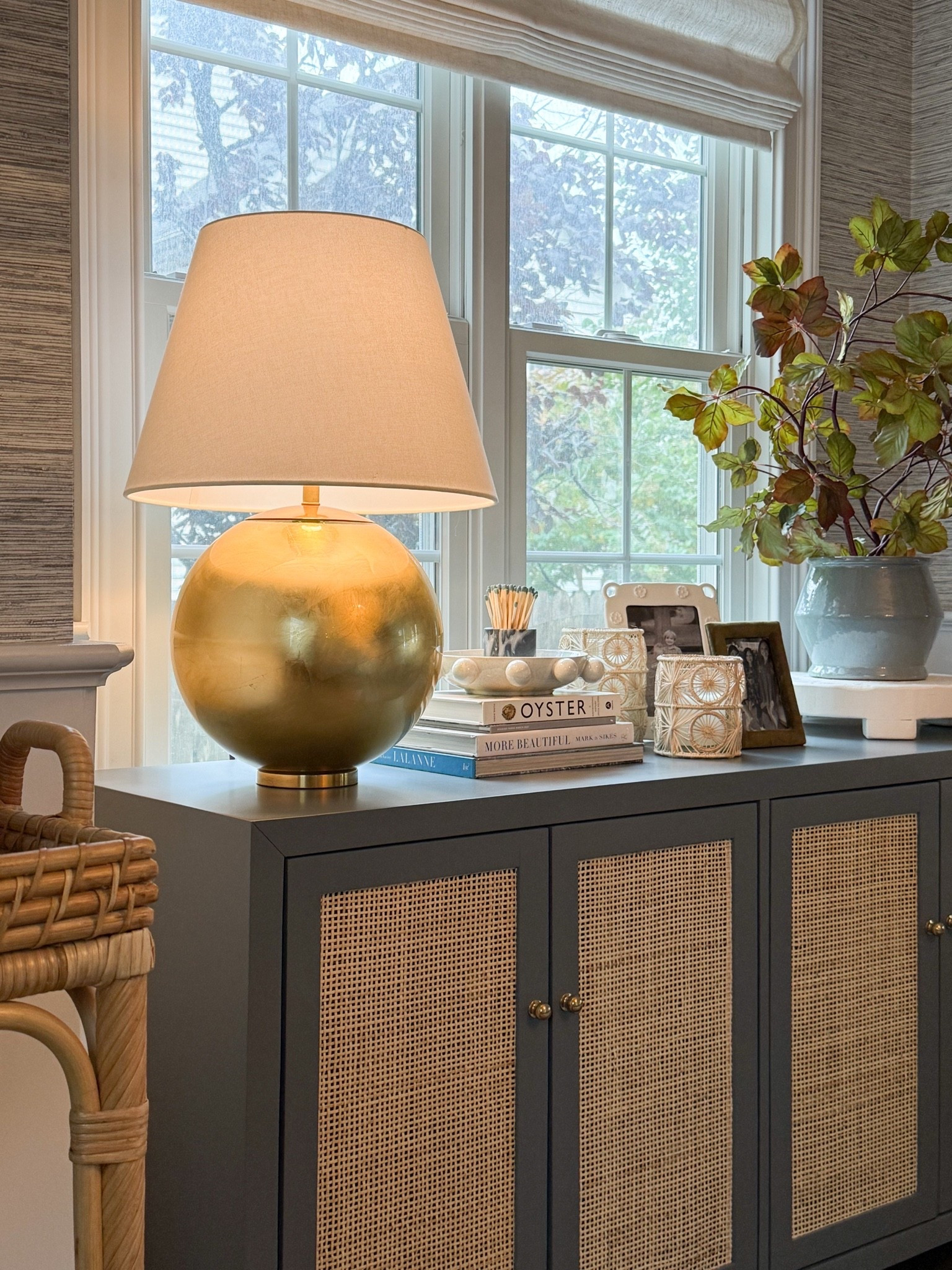 This oversized brass lamp is one of my favorite accent pieces because it brings so much warmth to this corner. The rounded metallic base makes a statement, while the oversized linen shade keeps it feeling soft and timeless. I love using table lamps like this to create layered lighting that feels cozy in the evenings without relying on overhead lights. Brass table lamp, oversized lamp, layered lighting, living room decor, neutral home decor, woven cabinet, home styling, accent lighting, timeless interiors, GirlOnTheHudson

#LTKHome